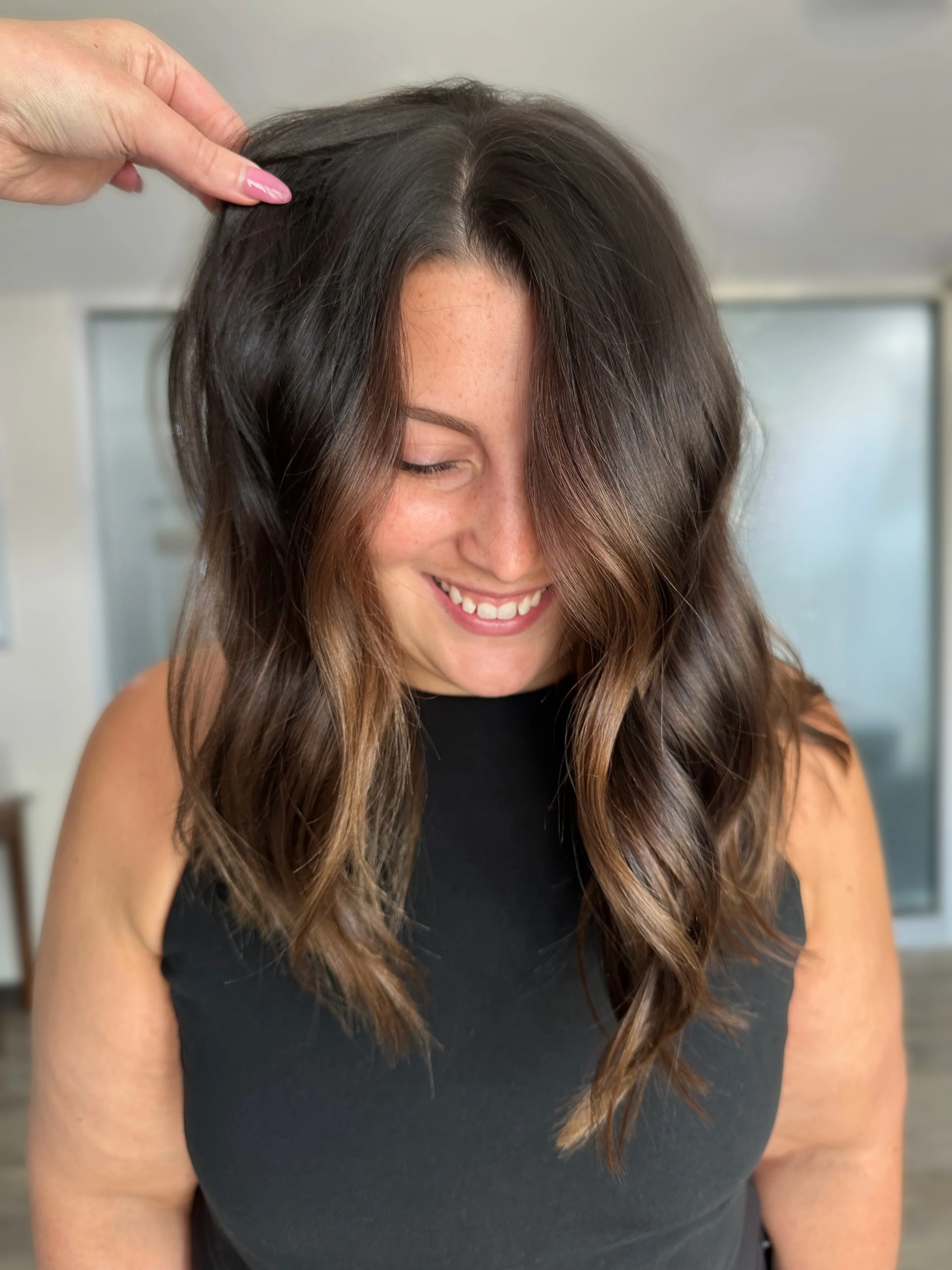 Brunette balayage with soft waves at Grand Noir Salon in Verona, WI