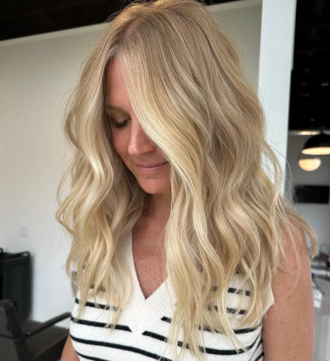 Soft golden blonde highlights with face framing at Grand Noir Salon in Verona, WI