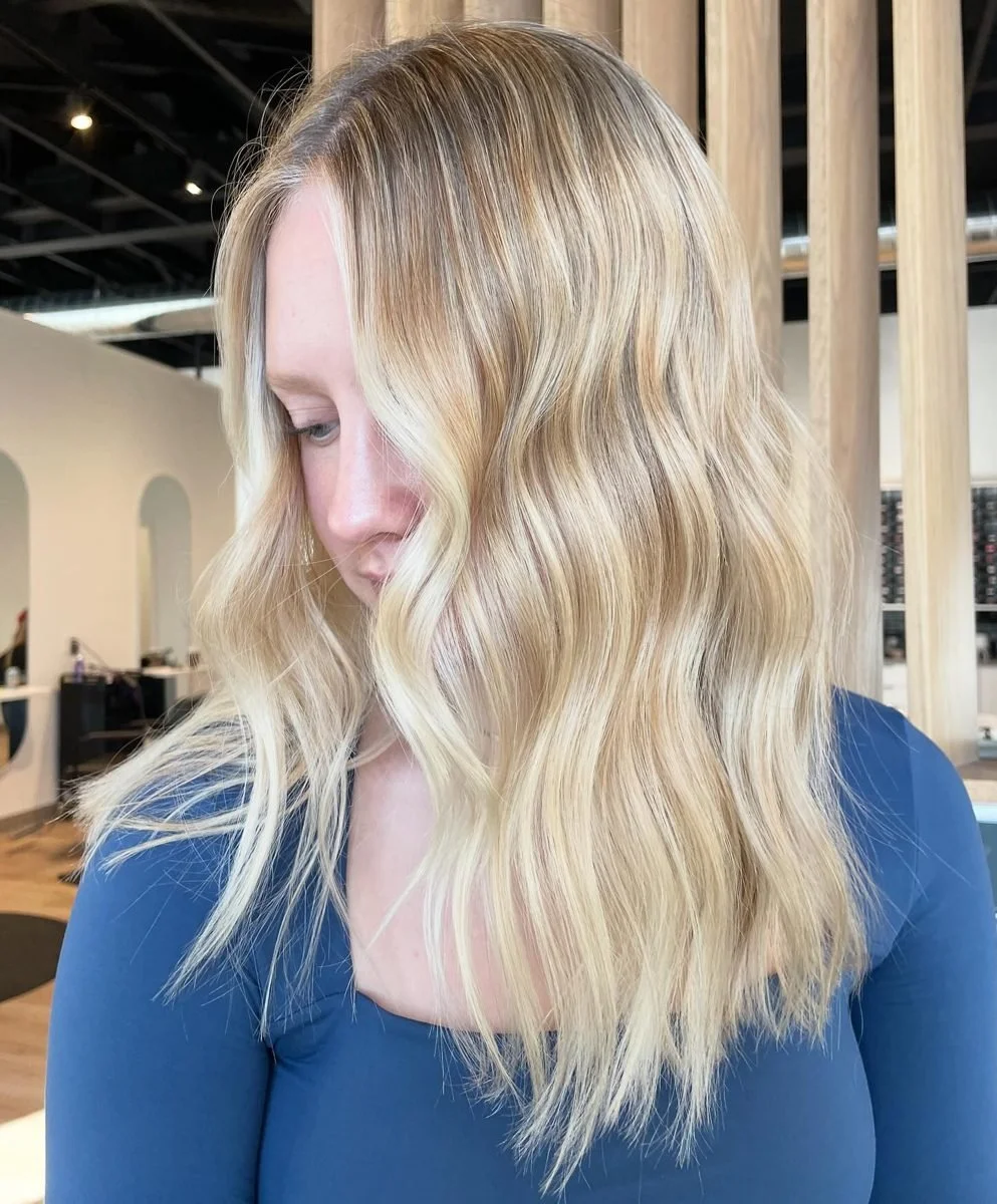 Bright blonde balayage on medium length hair at Grand Noir Salon, a hair salon near Madison, WI