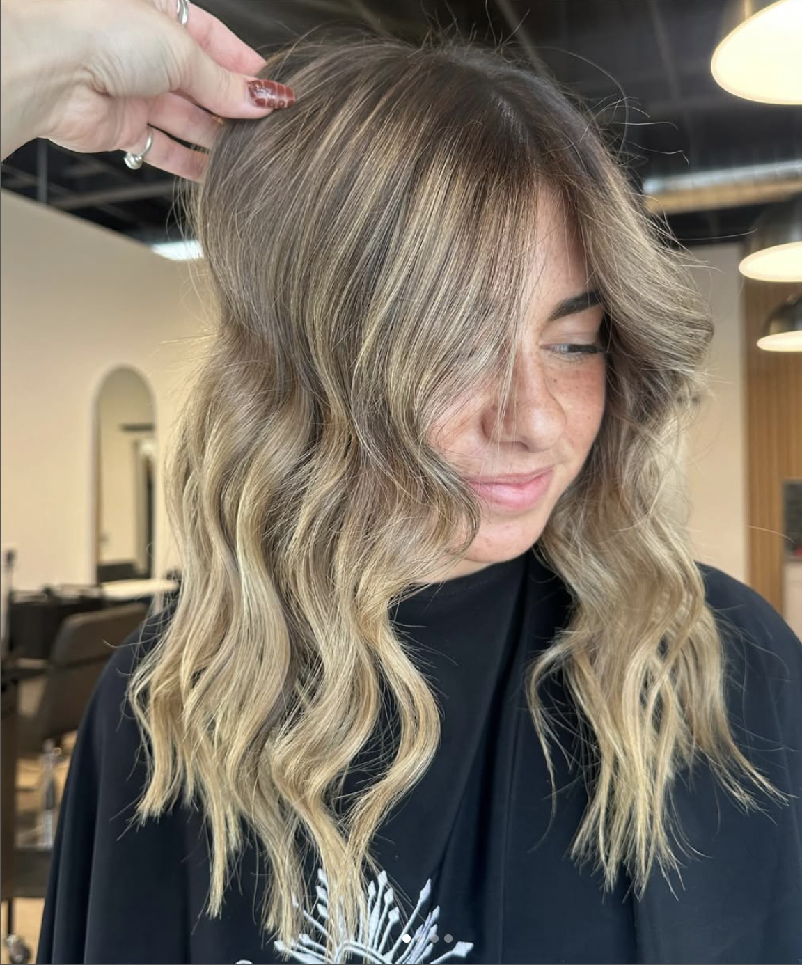 Dimensional bronde balayage with curtain bangs at Grand Noir Salon in Verona, WI
