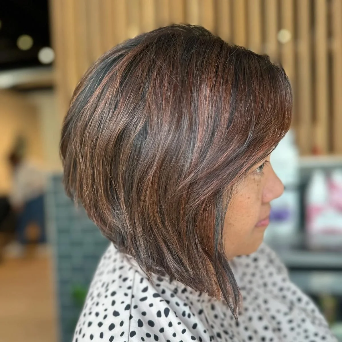 Angled bob haircut with copper highlights at Grand Noir Salon in Verona, WI