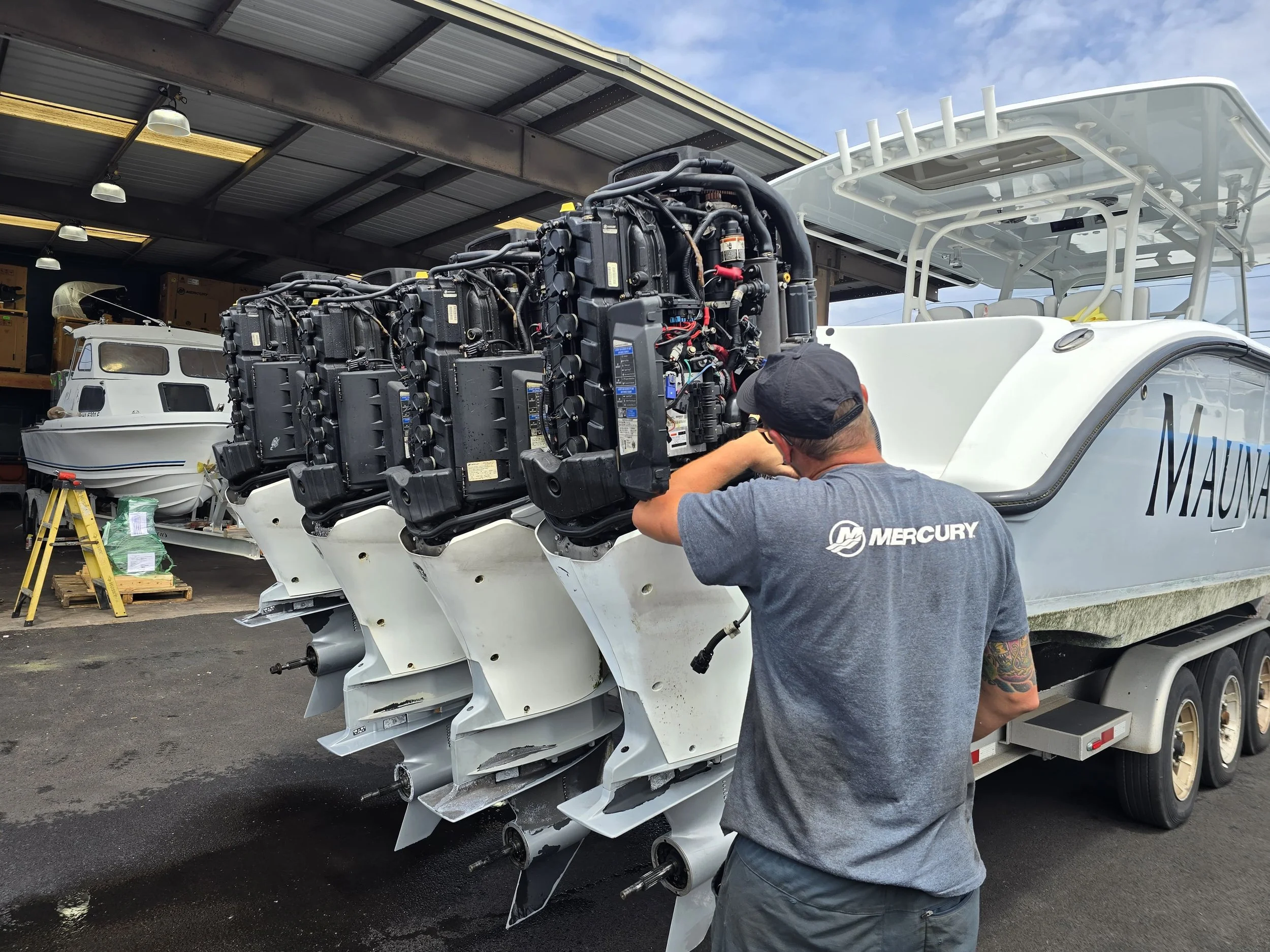 Riddle Marine Certified Mechanic working on Mercury Suzuki and Yamaha Outboards