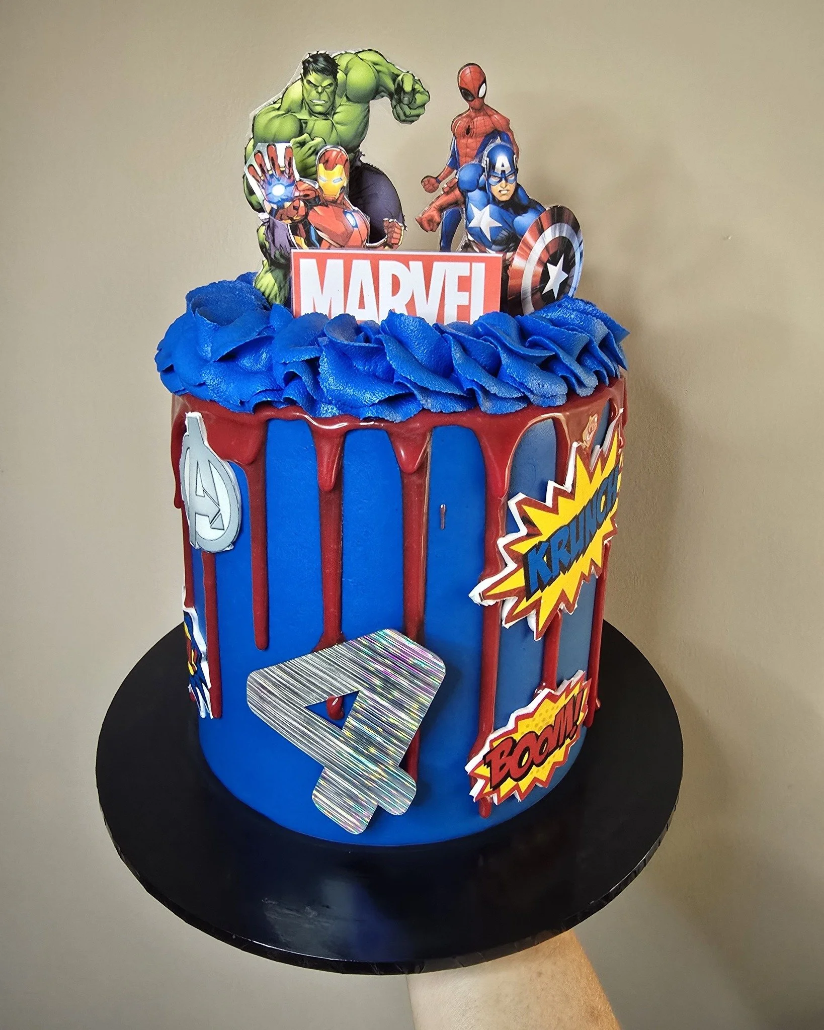 This super fun, superhero Avengers cake is unreal! 

Bright blue Swiss meringue buttercream with avengers toppers all over. 

A child's dream cake! 

I will be making a superhero cake next month for my son so this is a great inspiration for that. 

I