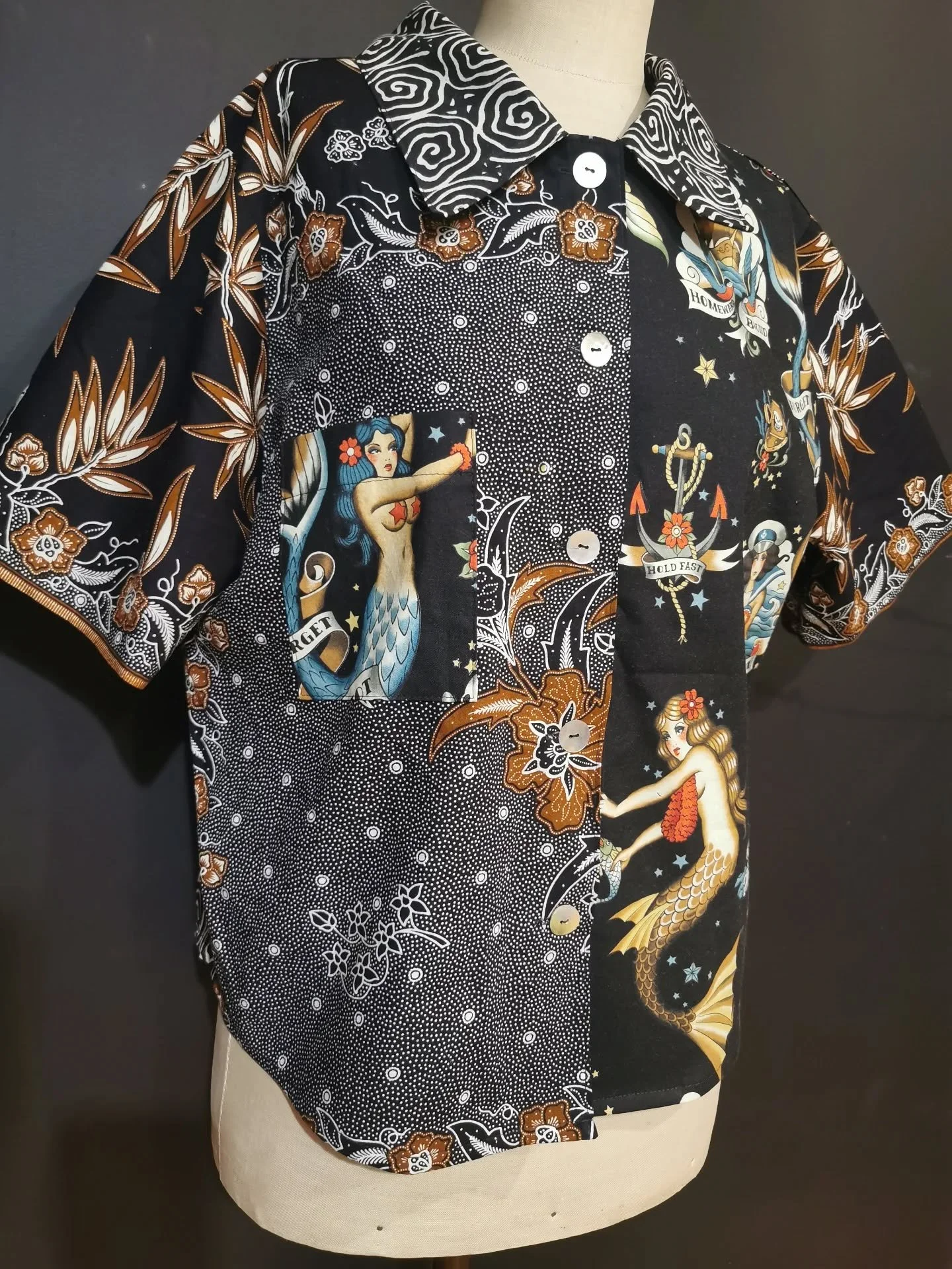 Mixing things up again....Global Harmony button up shirt.
Fabulous black and white batiks from Bali and India, teamed with a cool old school tattoo print (by renowned American tattooist Ed Hardy and Alexander Henry fabrics) Love the mermaids. And fin