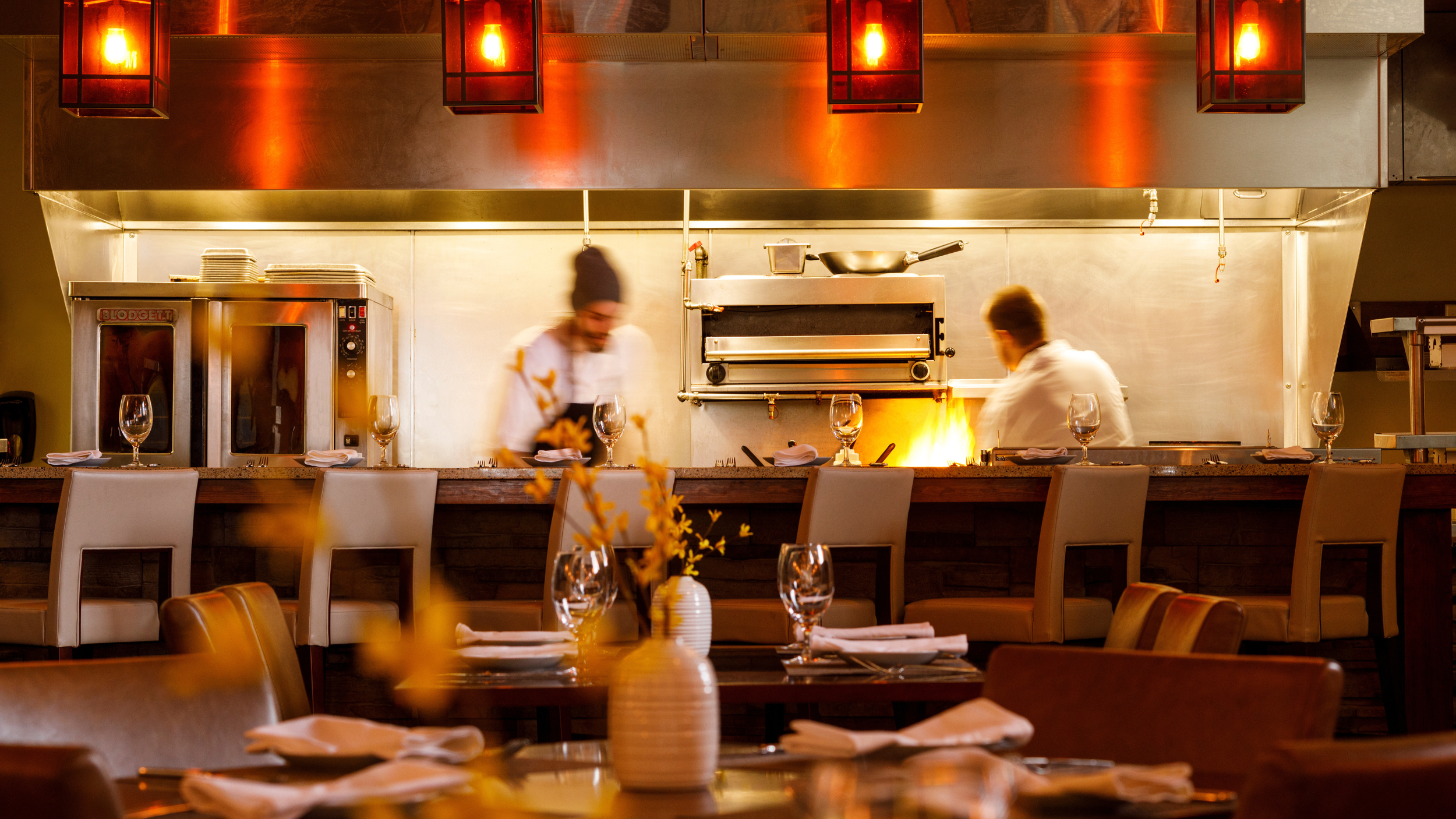 Chefs cooking in an industrial kitchen.