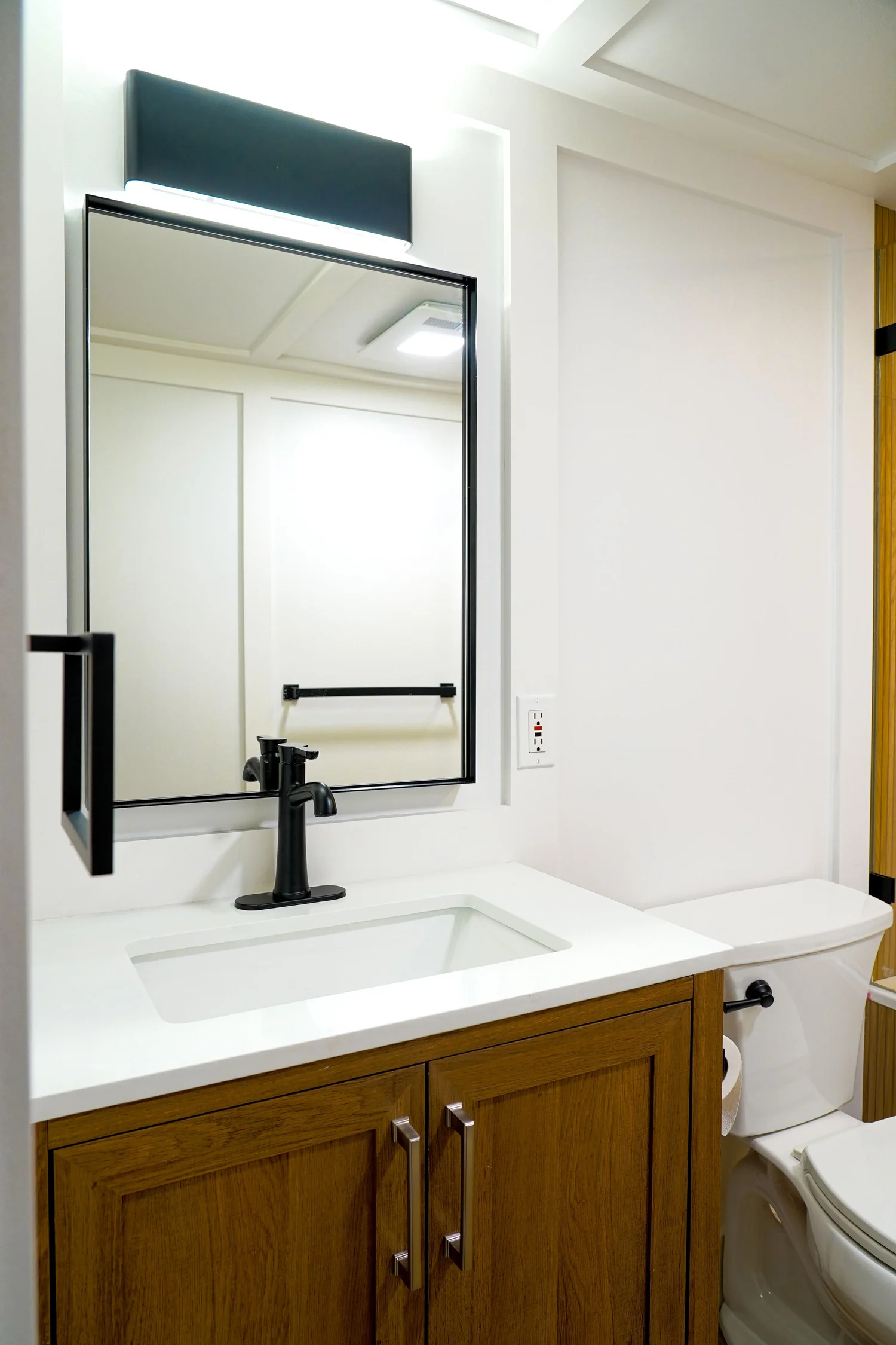 Wood-Tone Bathroom & Glass Shower — photograph 3