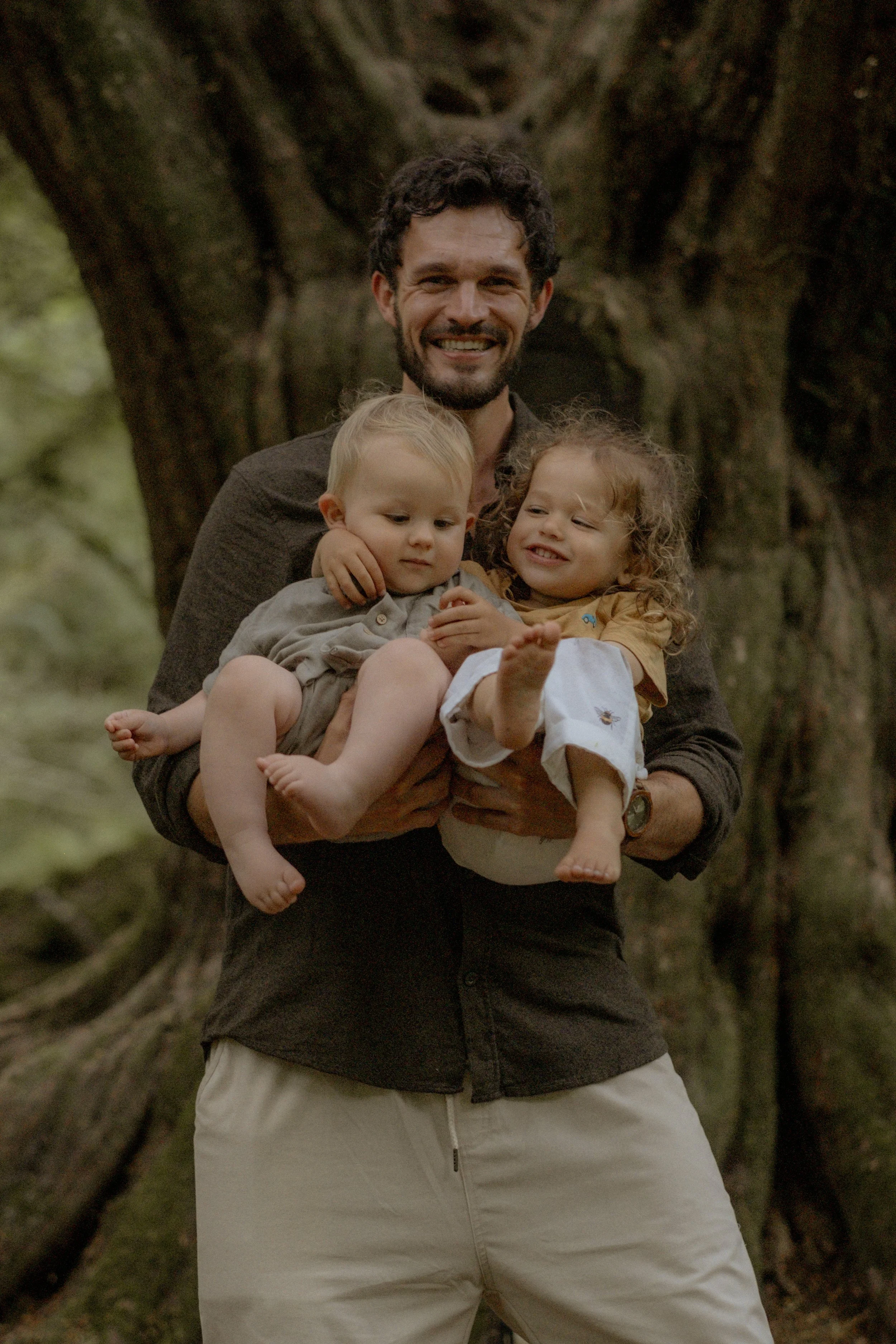 Father and toddlers during a relaxed, natural  outdoor photoshoot in Wales