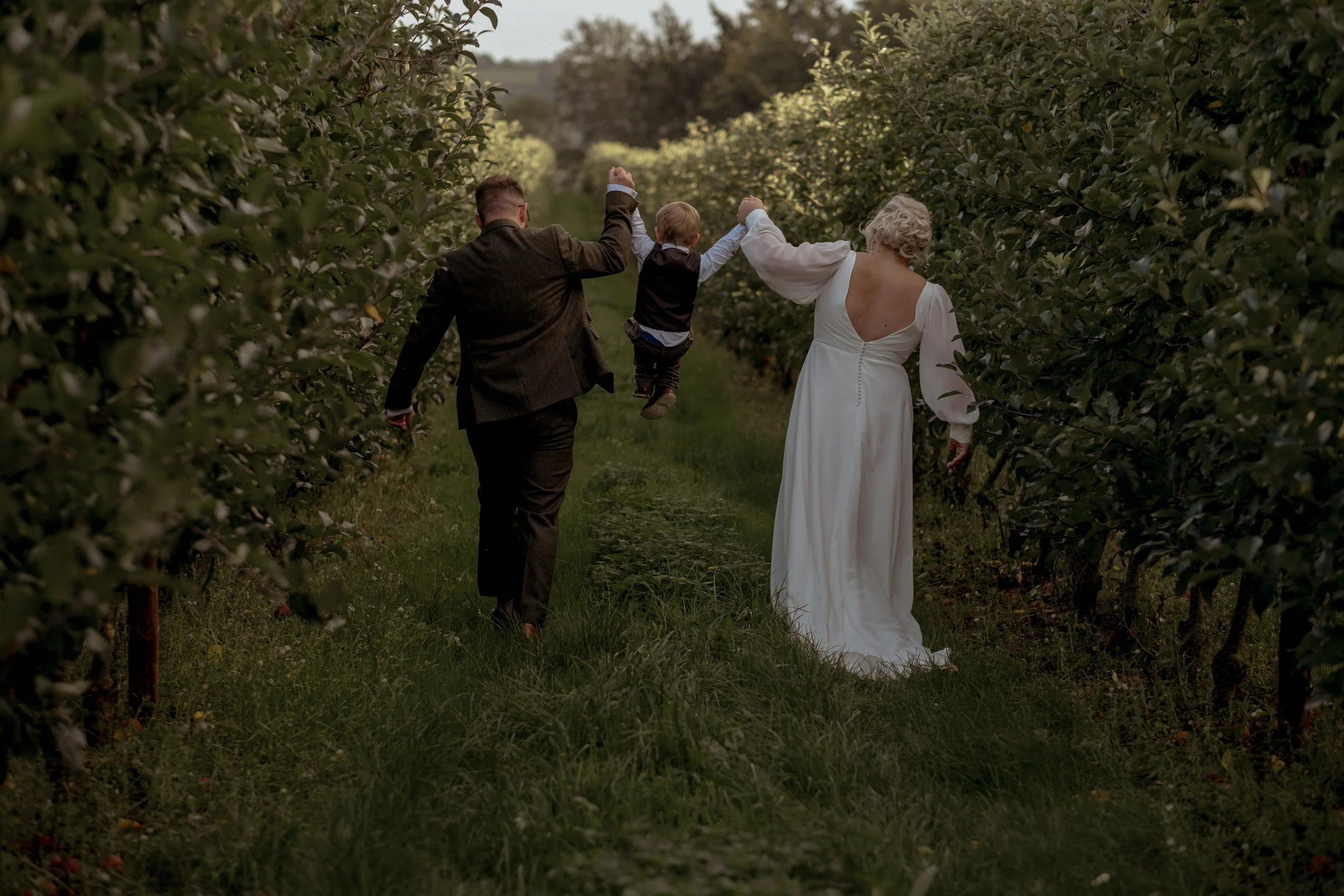Natural family photo taken outdoors in apple orchard at Glewstone court, Ross on wye 