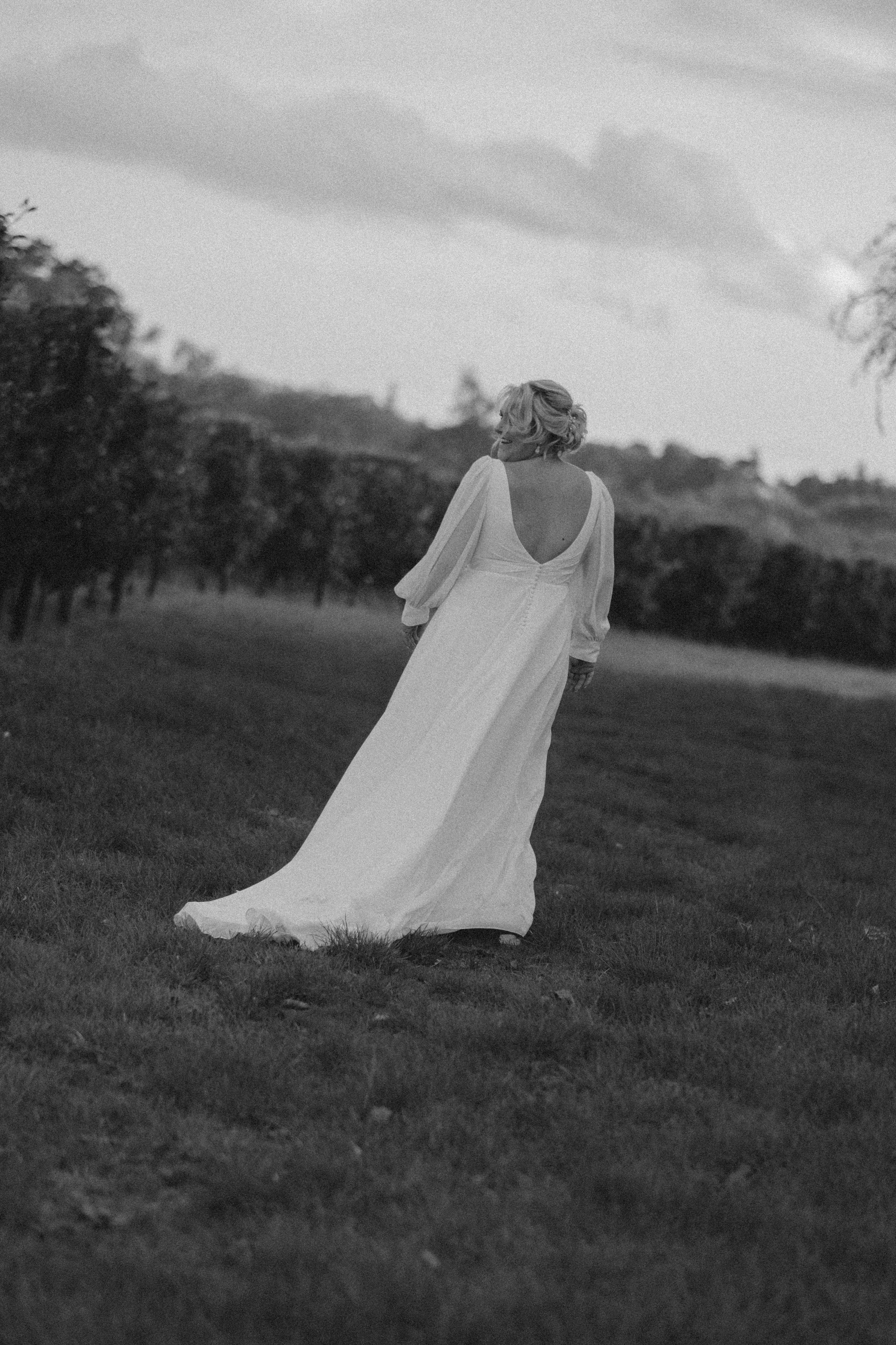 Natural Black and white, romantic Wedding photography moment, capturing a bride outdoors in apple orchard at Glewstone Court, Ross on Wye