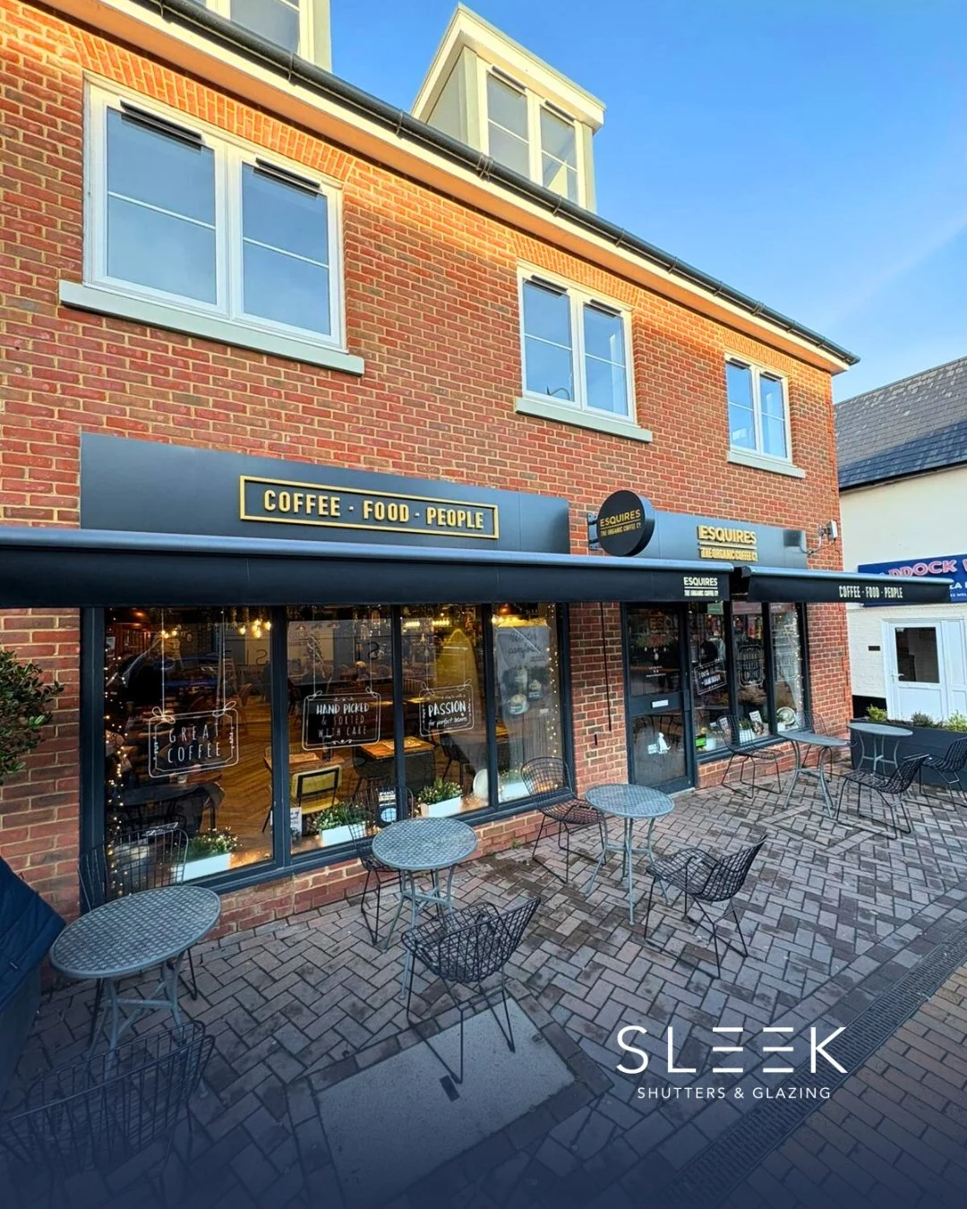 Picture of a coffee shop with an awning installed by Sleek Shutters and Glazing