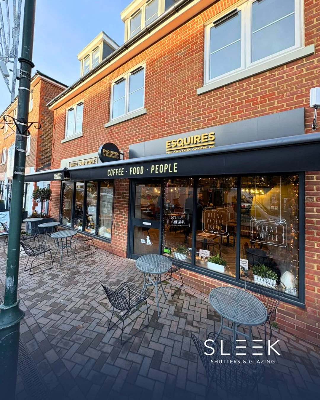 Picture of a coffee shop with an awning installed by Sleek Shutters and Glazing