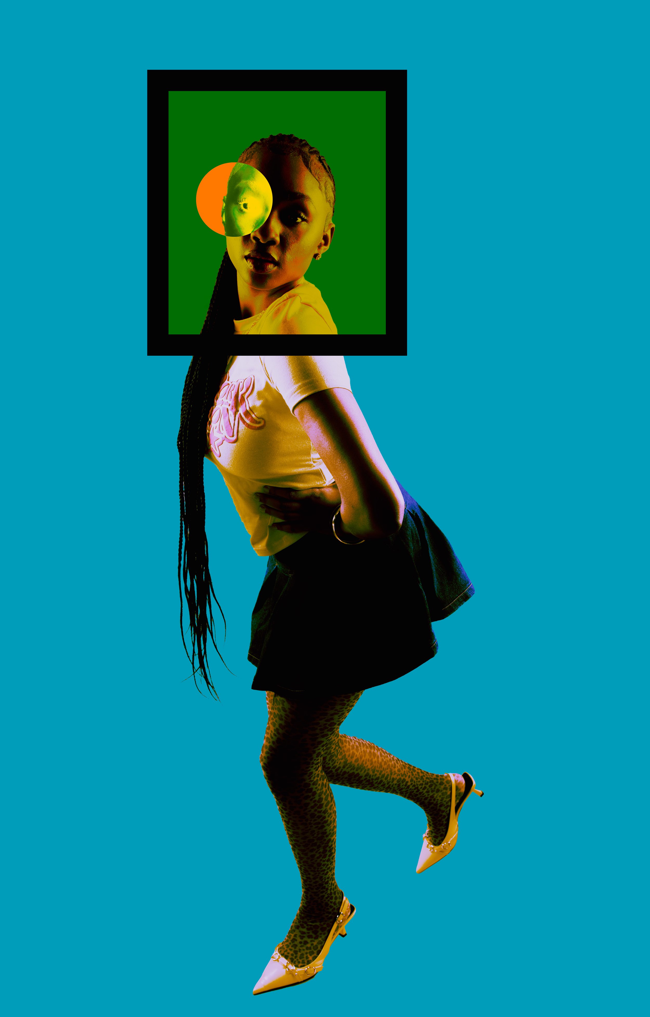 A woman with braided hair is standing against a plain teal background. Her head is in a framed picture with a green background, a yellow half-circle, and a distorted face overlay covering one eye. She is wearing a yellow top with pink design, a black