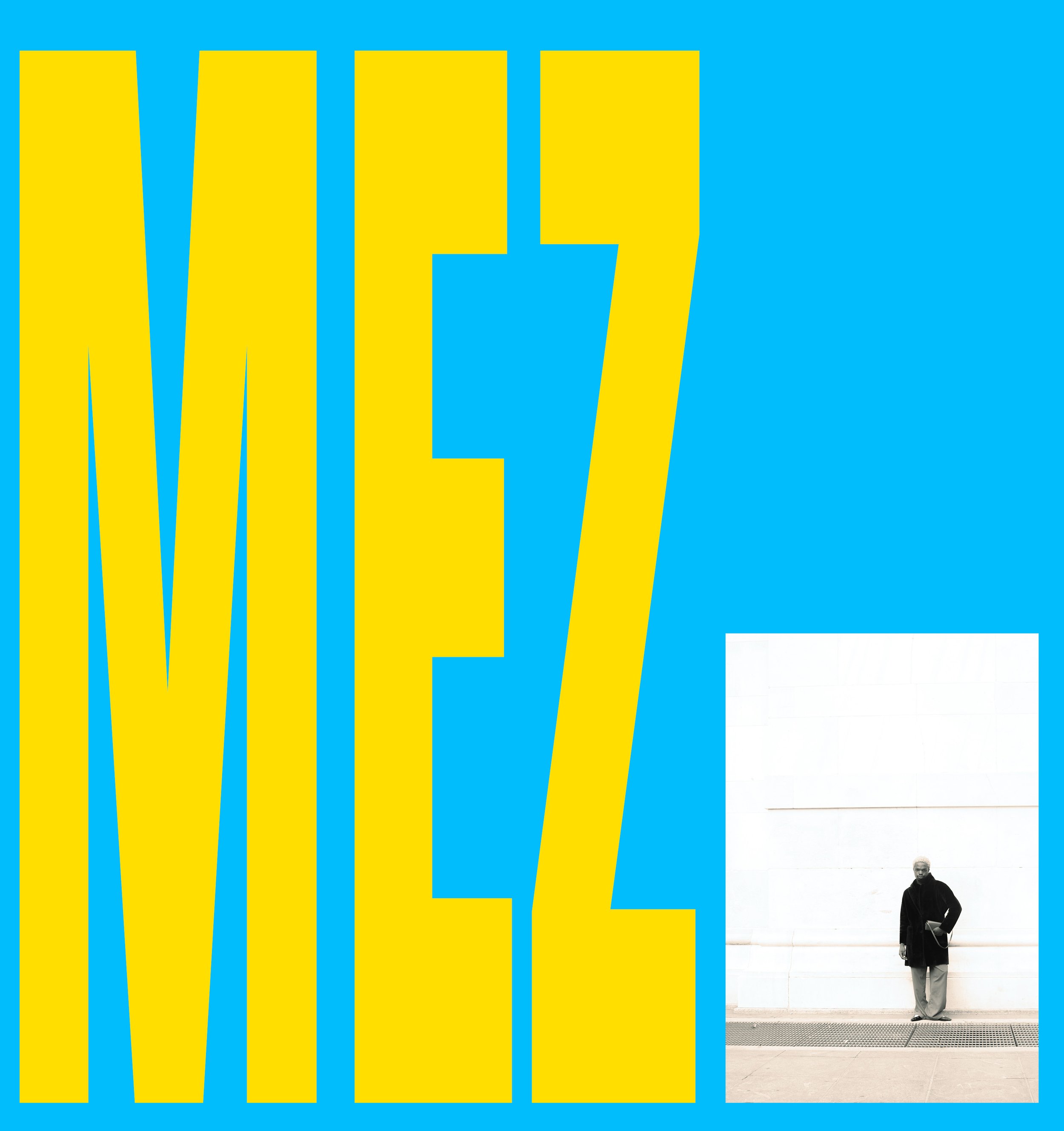 An art installation of the word "Mez" in large yellow letters on a bright blue background, with a photo of a man in a black coat and glasses holding a bag, standing next to a white wall with the illuminated letters.