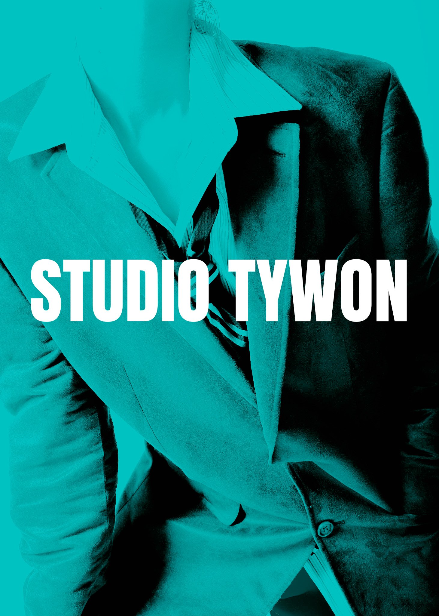 Close-up of a person wearing a light-colored blazer, striped shirt, and dark pants, with the words 'STUDIO TWO' overlaid in large white text.