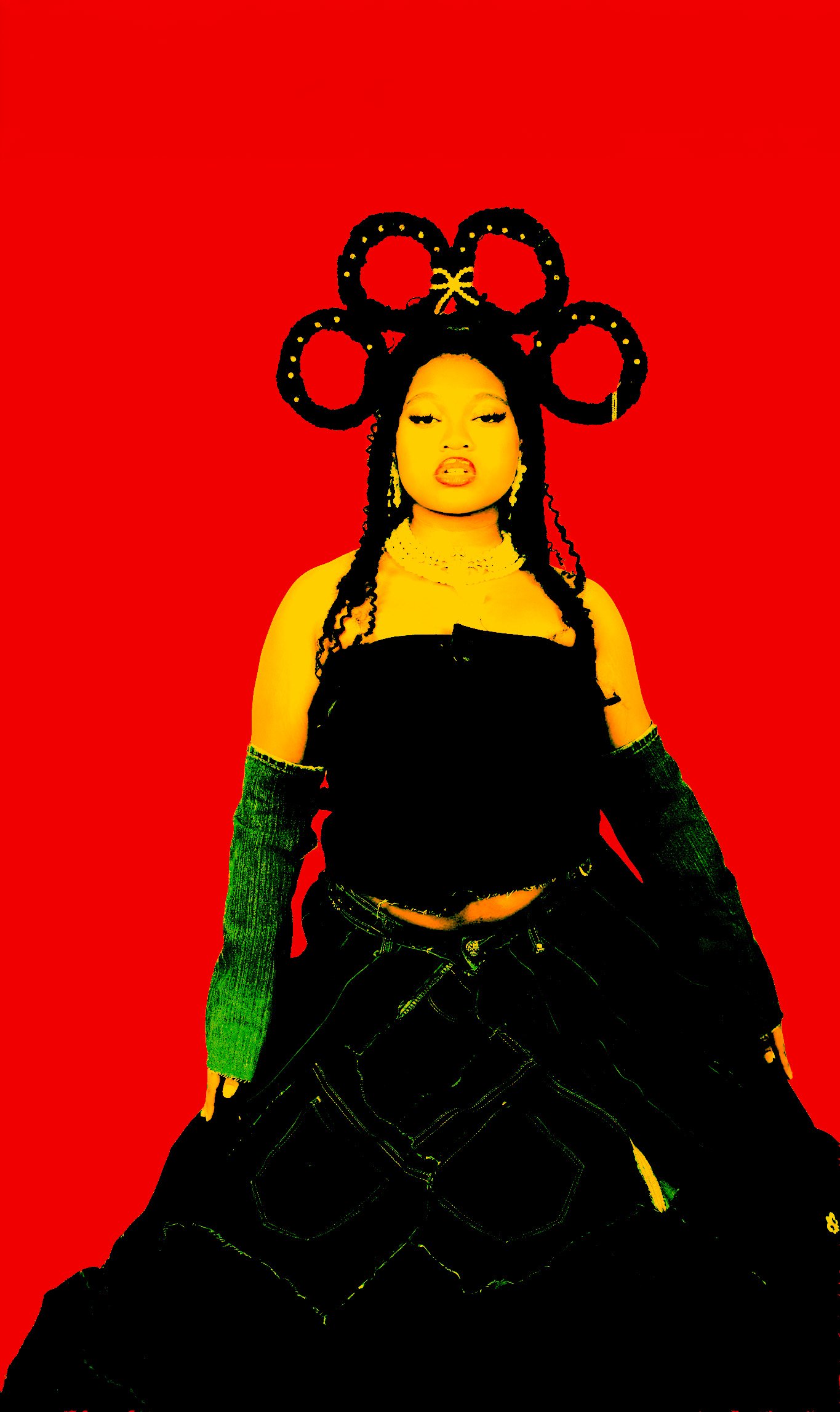 A woman with dark braided hair styled in large loops, wearing a yellow top with off-the-shoulder sleeves, layered necklaces, and black shorts with yellow stitching, standing against a bright red background.
