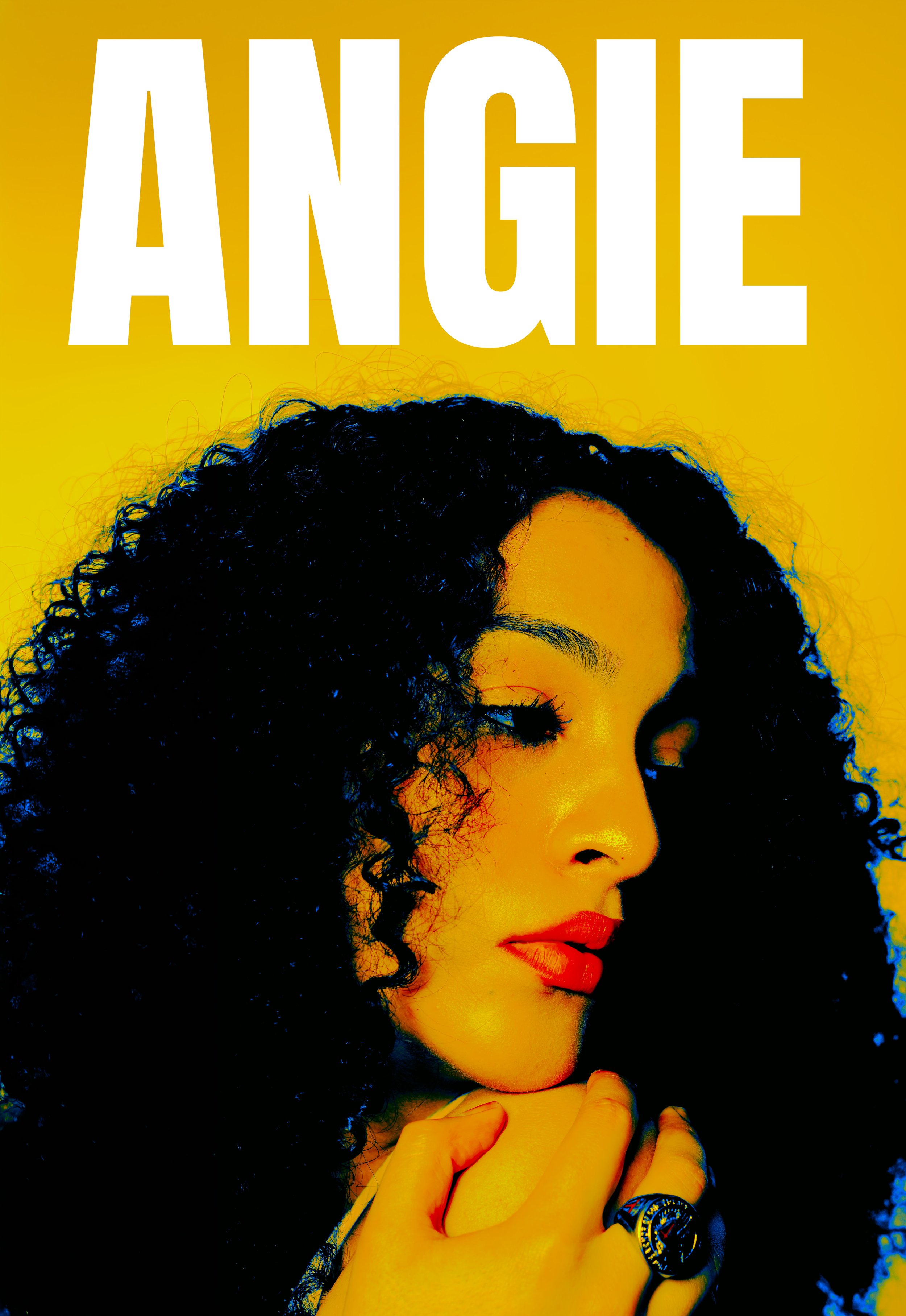 Close-up of a woman with curly black hair, red lipstick, wearing a large ring, against a yellow background. The word "ANGIE" is written in large white letters at the top.