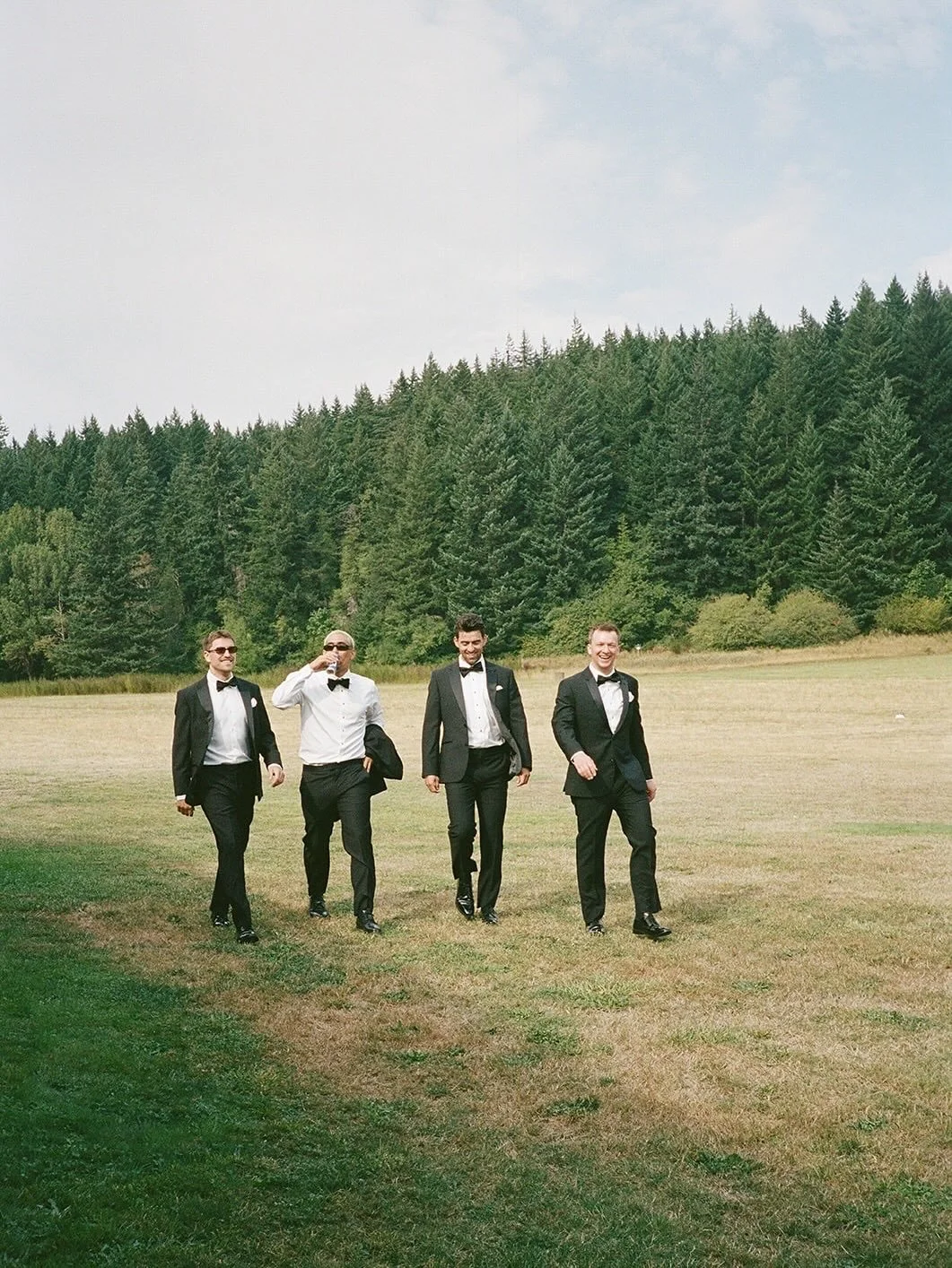 Bunch of dapper gents cruising through the field, en route to the festivities. We&rsquo;ve got plenty of room at the Ranch for your bffs &amp; family &mdash; 7 cabins for you and your crew. When you book the Ranch, you have private access to hang and