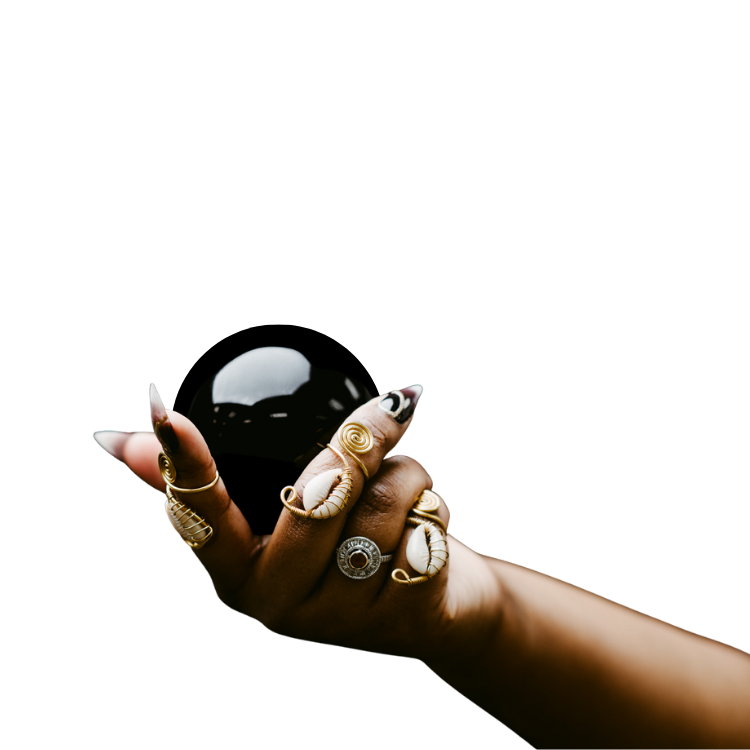 Samar's hand holding a black crystal ball.