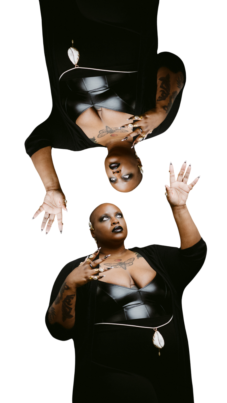 Samar wearing all black with their left hand reaching up towards a reflection of them.