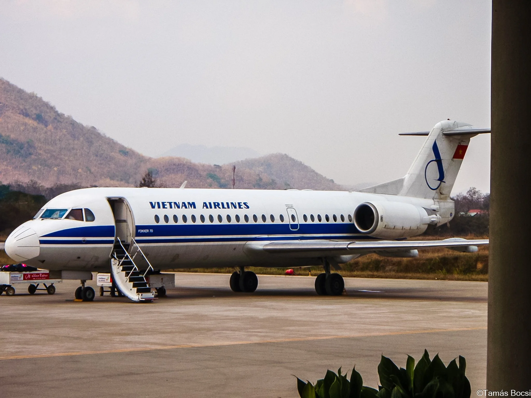 Vietnam Airlines airplane on the tarmac with mountains in the background