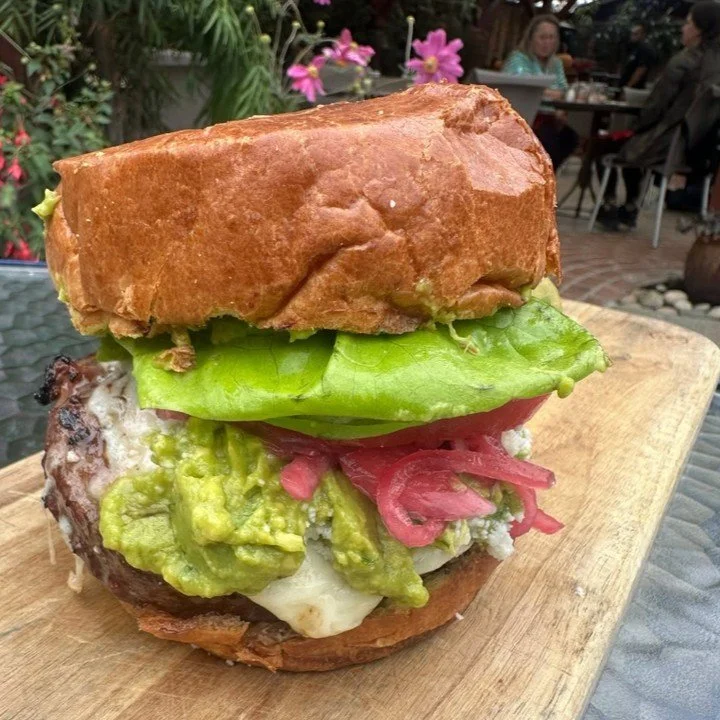 Burger Tuesday is calling! 🍔 Settle in tonight with our specialty Hamburguesa: Hearst Ranch 100% grass-fed patty infused with bacon &amp; caramelized onions, topped with guacamole, pickled onions, queso fresco, all on a brioche bun. Served with frie