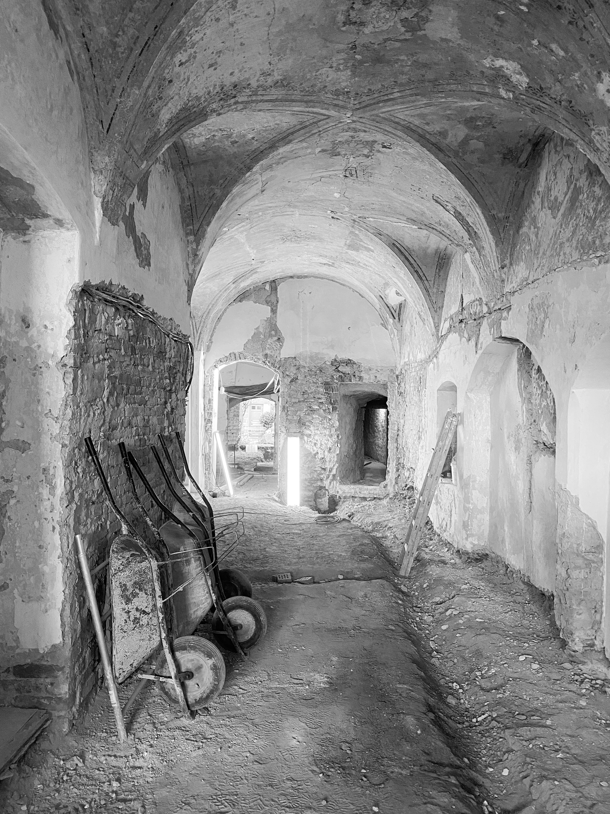 Foyer before the renovation of a historic landmark: Renaissance vaults and exposed masonry, black-and-white photograph