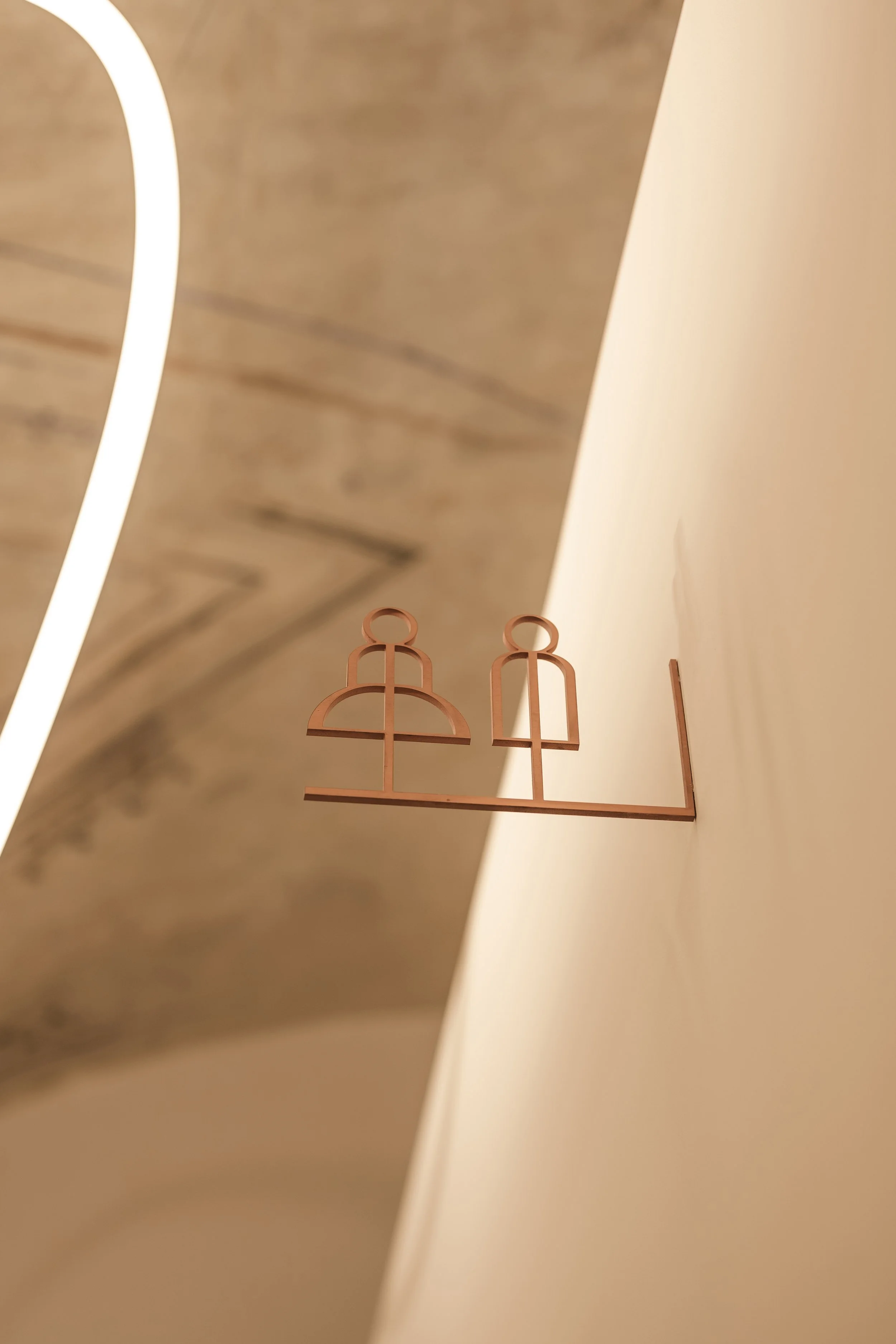 Wayfinding system: a pictogram milled into the wall near the vault