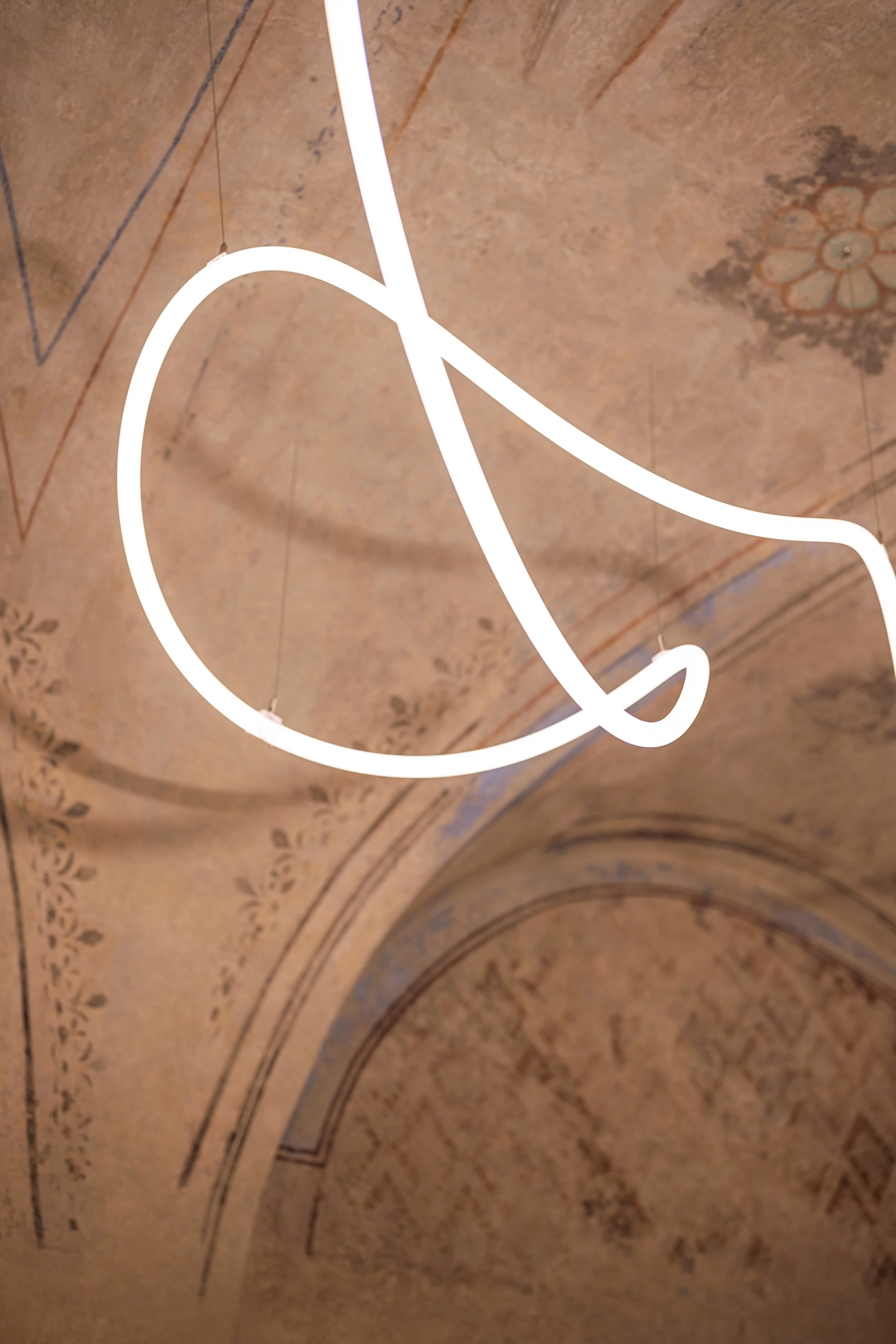 A glowing snake winding beneath the restored vault, detail