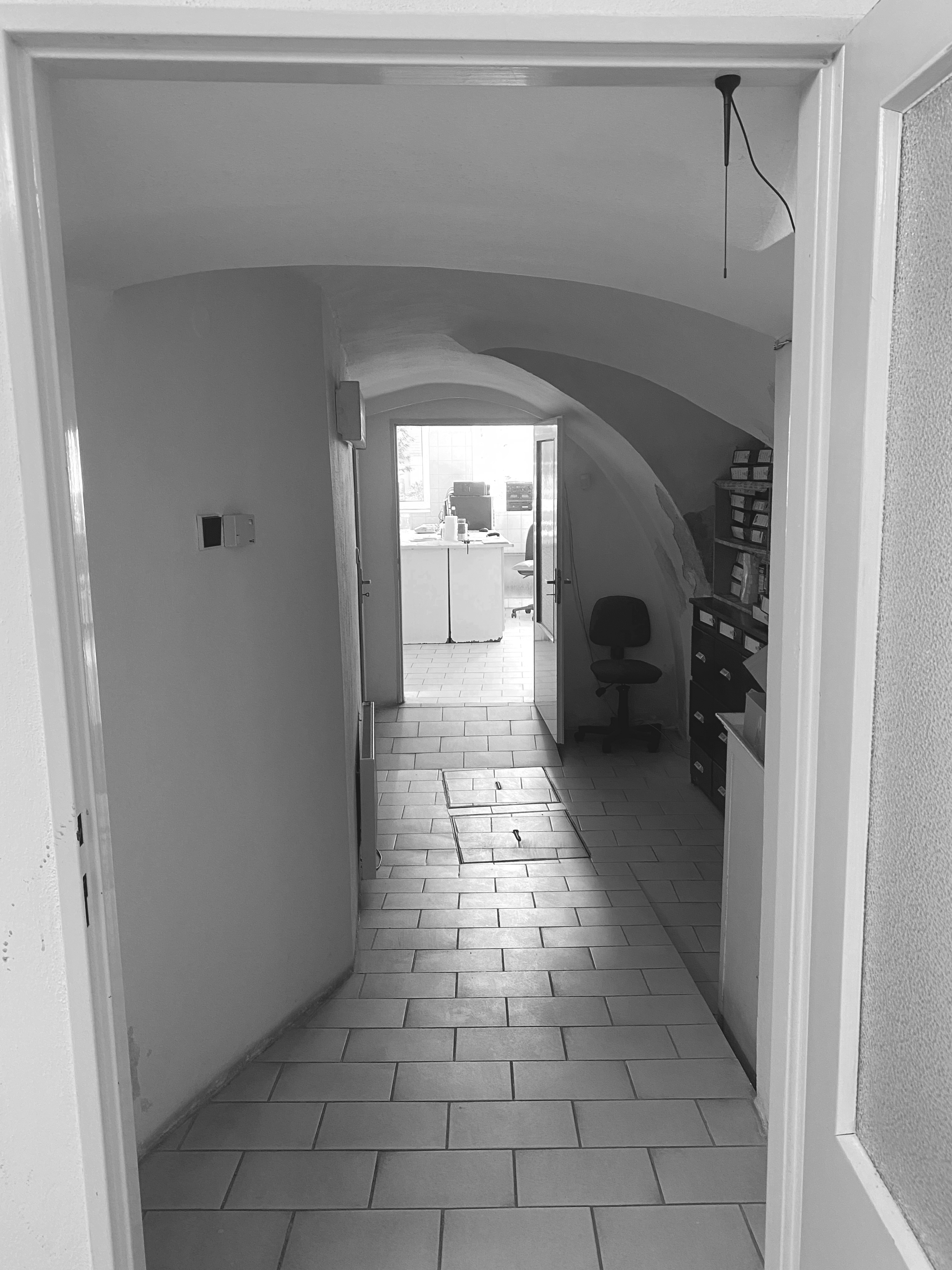 The original vaulted hallway before renovation, black-and-white photograph