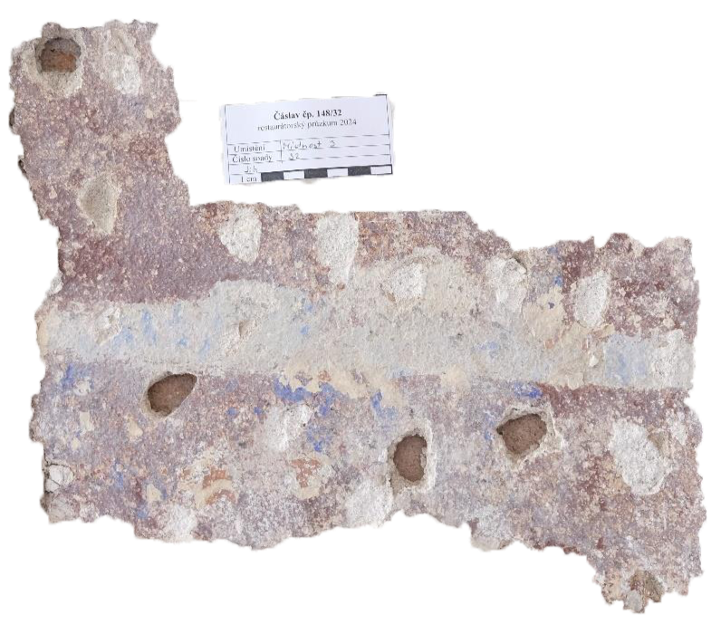 A restoration probe in the plaster revealing historical layers and pigments
