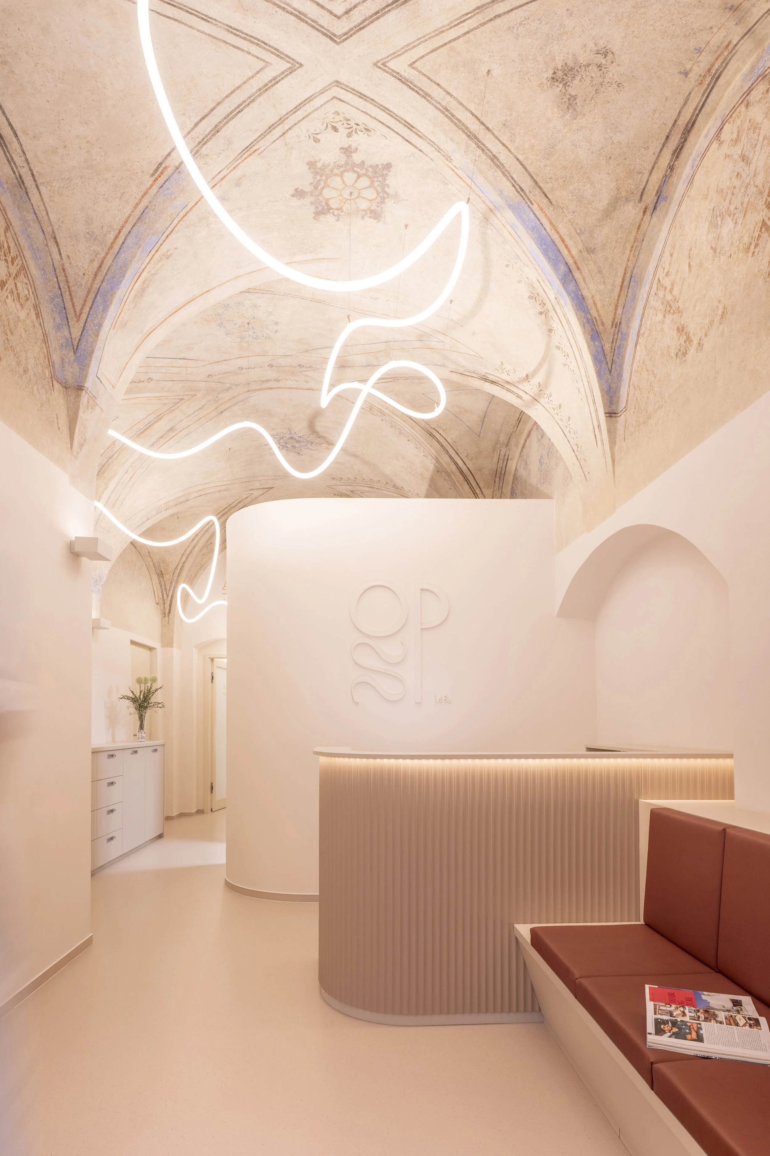 The same foyer after renovation: the clinic’s reception area beneath a restored Renaissance vault