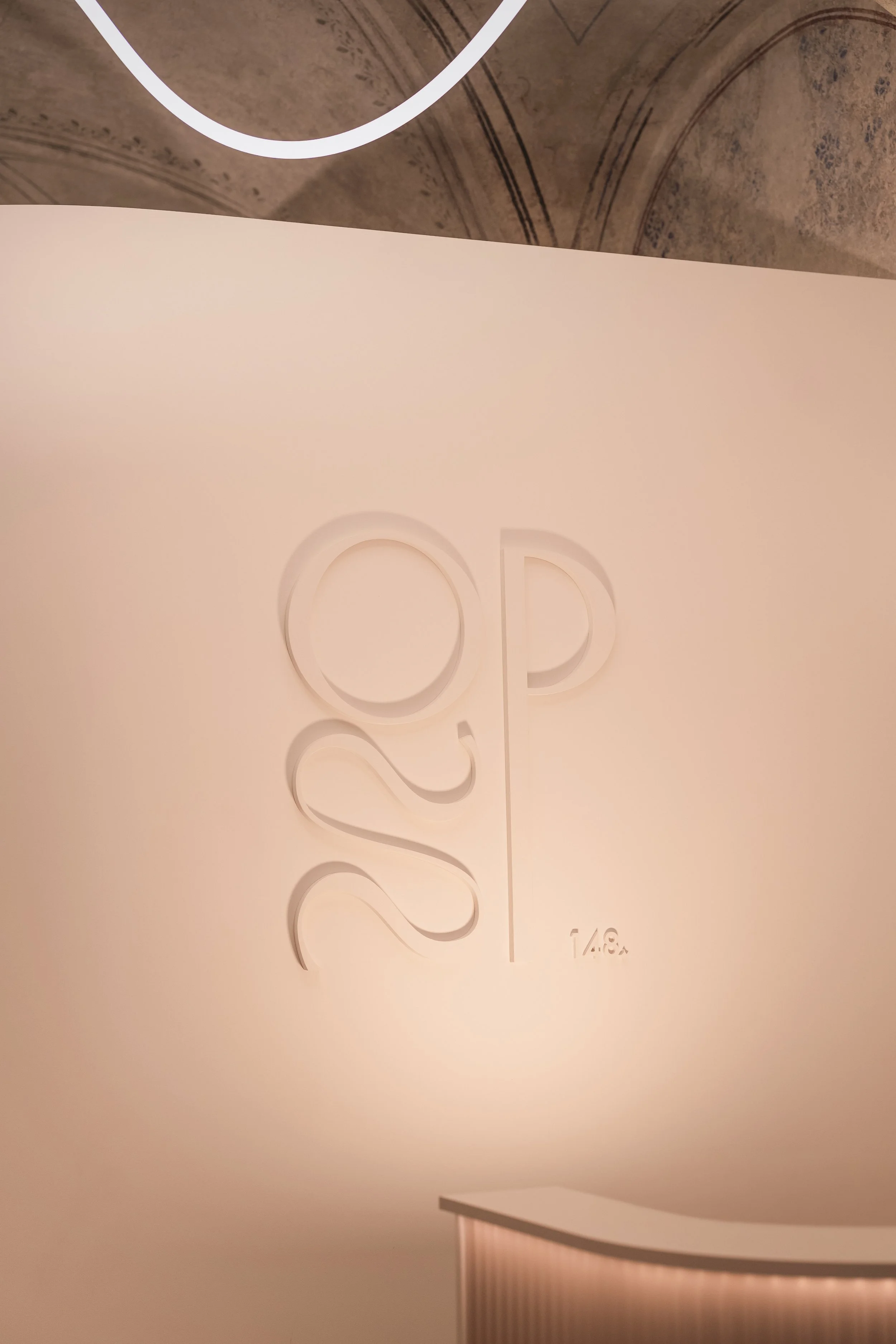 The " Ordinace Pod Štítem " logo milled into the reception desk