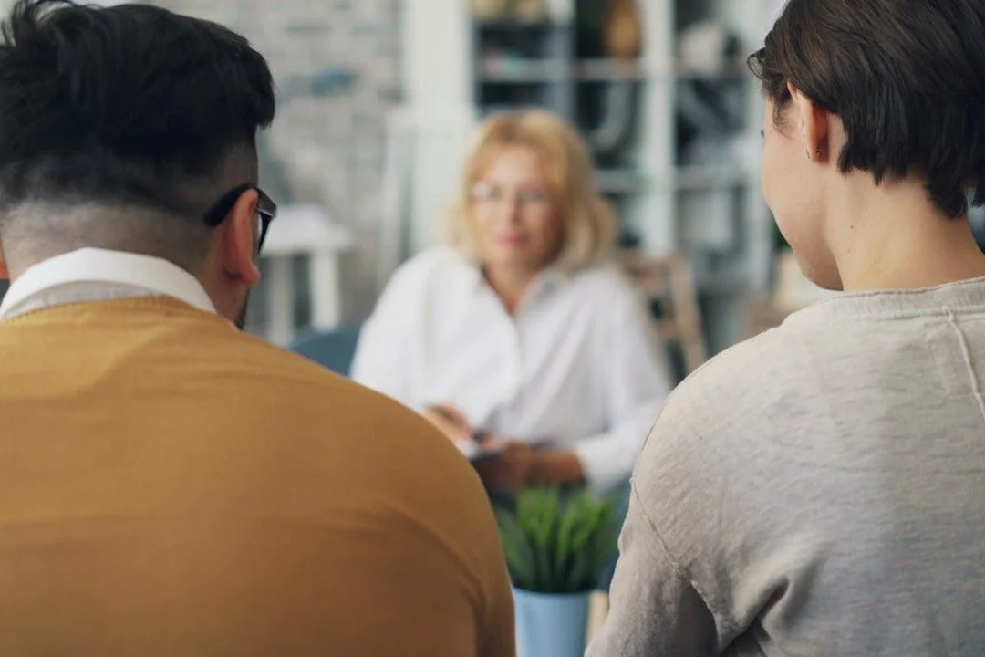 a-woman-and-man-sitting-at-a-table-talking