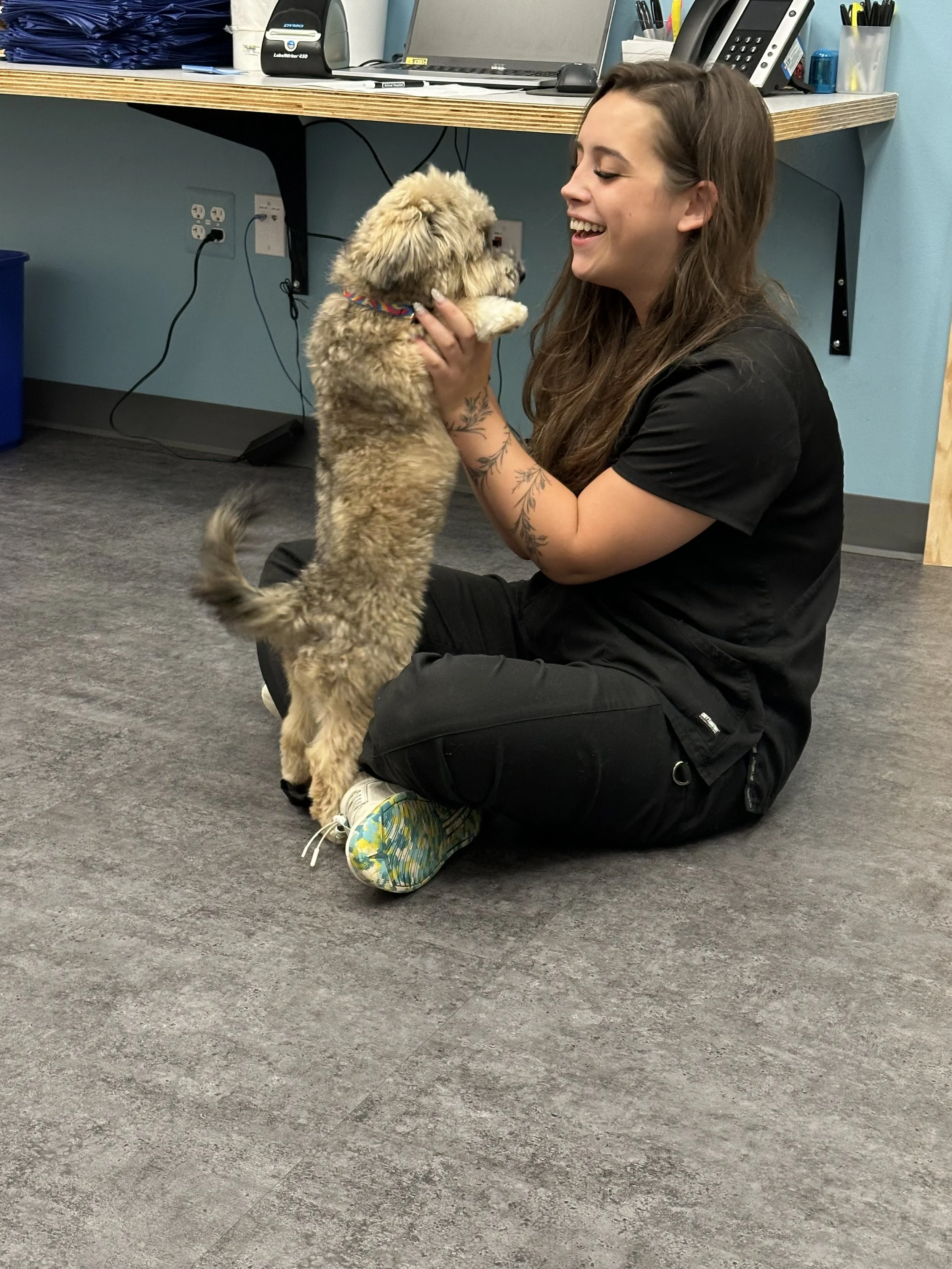 Nurse Tiana smiling at puppy Bogie