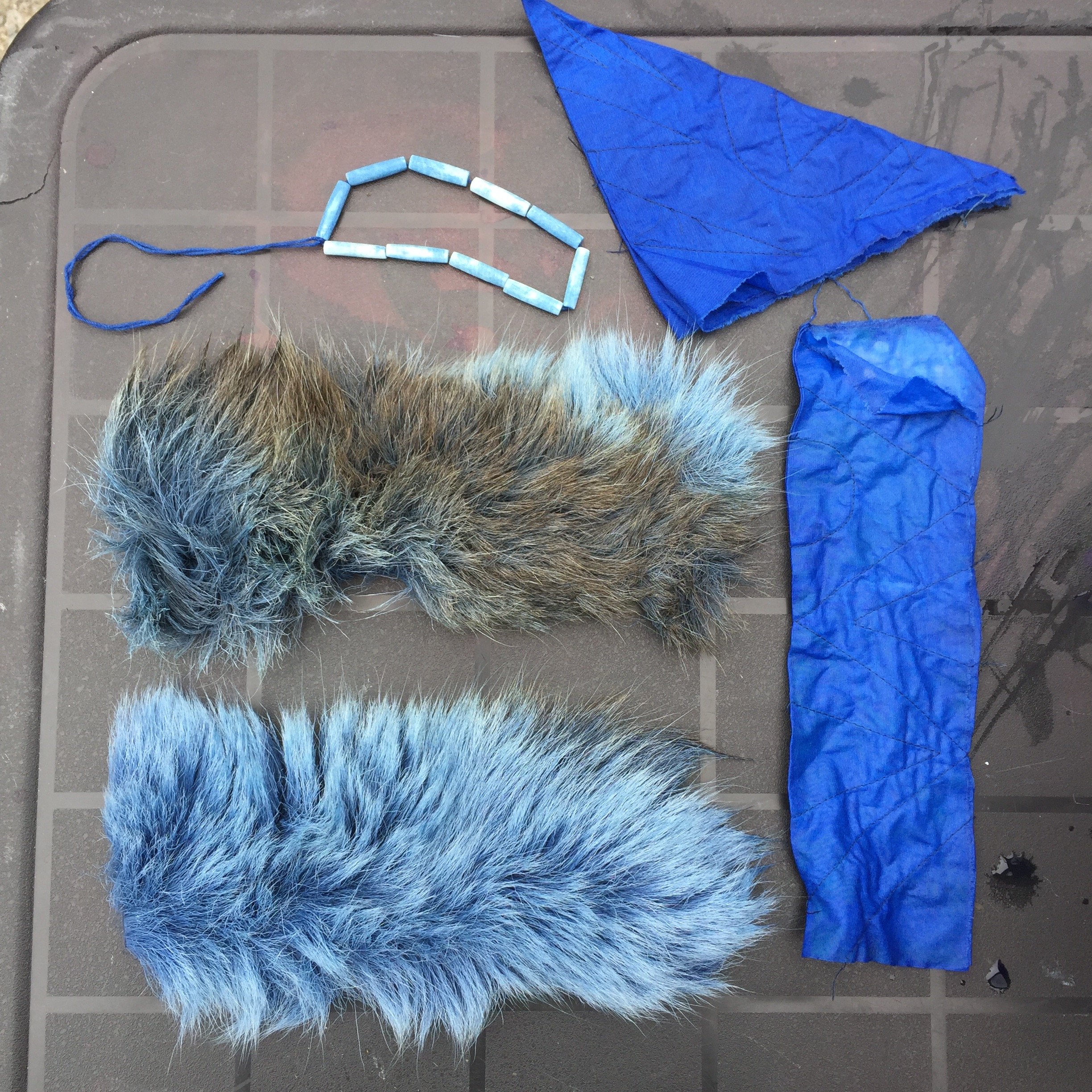 Indigo dyed cotton sewn shibori resist, bone pipe beads, moosehair.