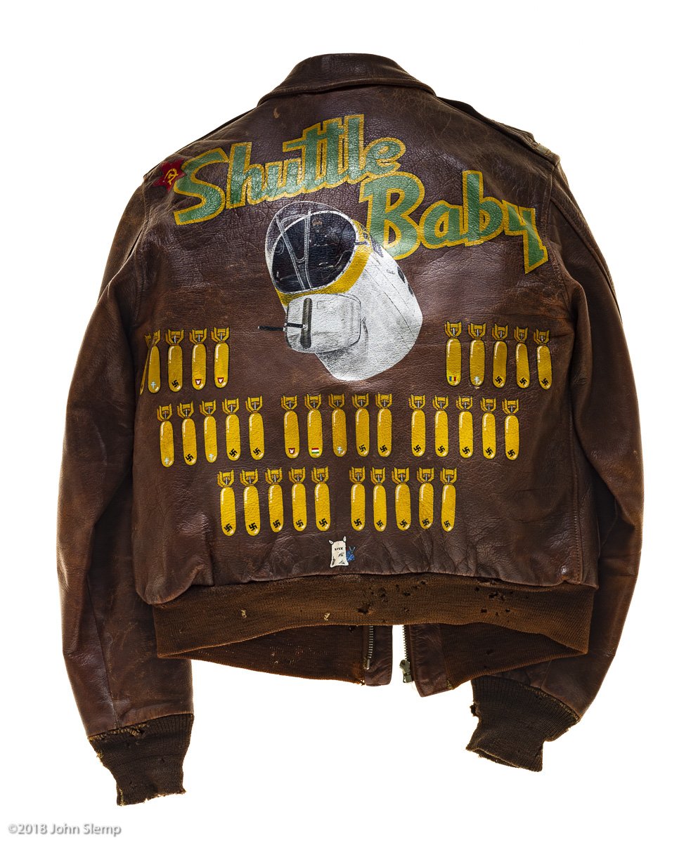 This type A-2 flight jacket belonged to William Quinn, a bombardier attached to the 570th squadron of the 390th Bomb Group. There are 35 bombs, signifying Quinn’s 35 successful missions.  Also notice the Russian Red Star symbol, denoting a "shuttle r