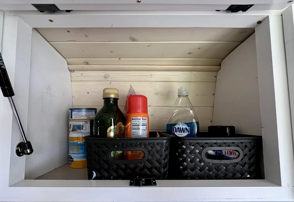  Upper cabinet used to store food and condiments in van camper kitchen 