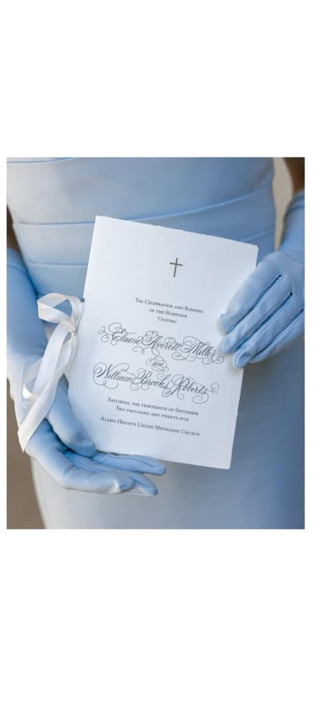 Bridesmaid holding a wedding program with calligraphy for a marriage ceremony.