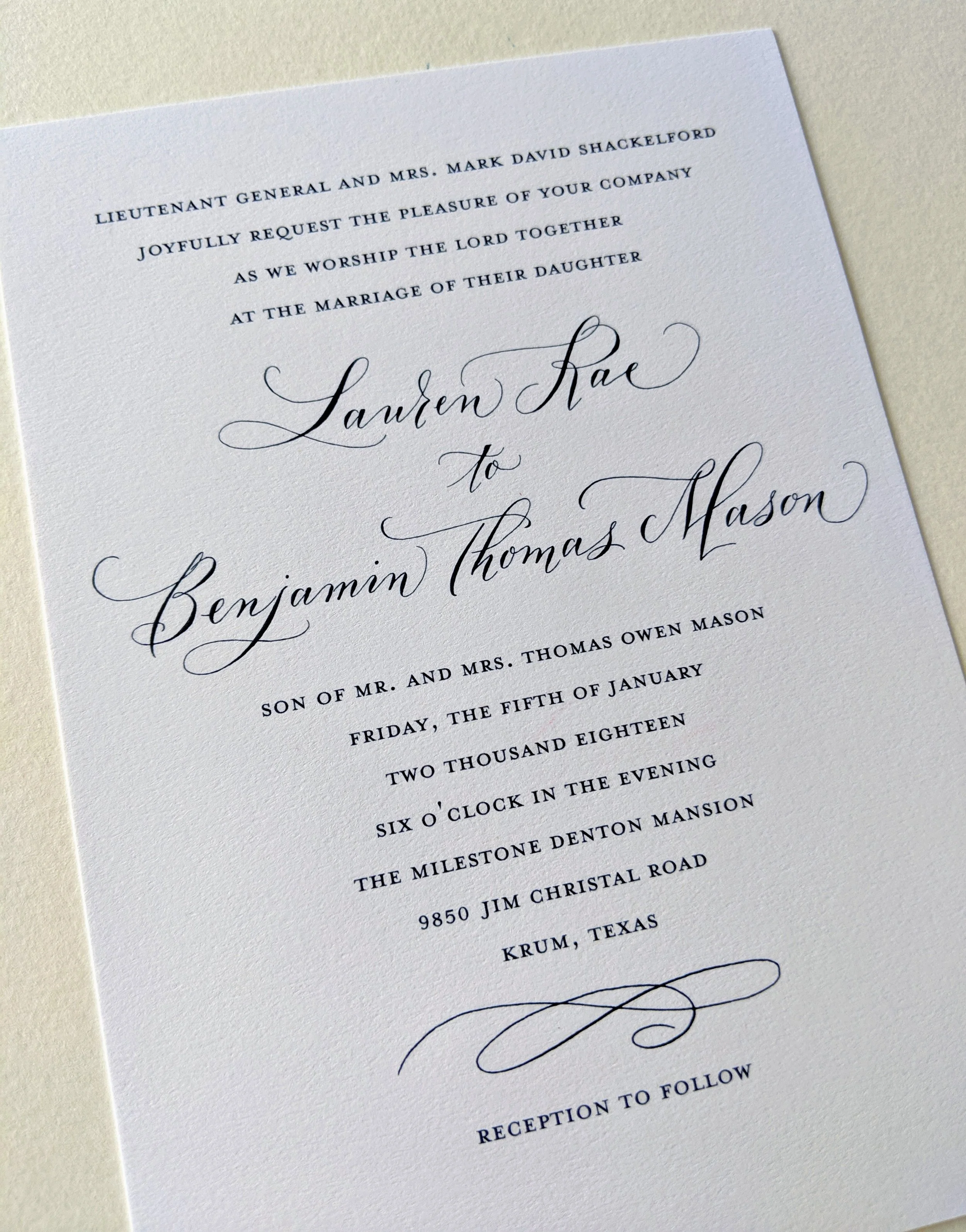 Elegant wedding invitation with modern black script text on white paper, including details of the marriage ceremony and reception.