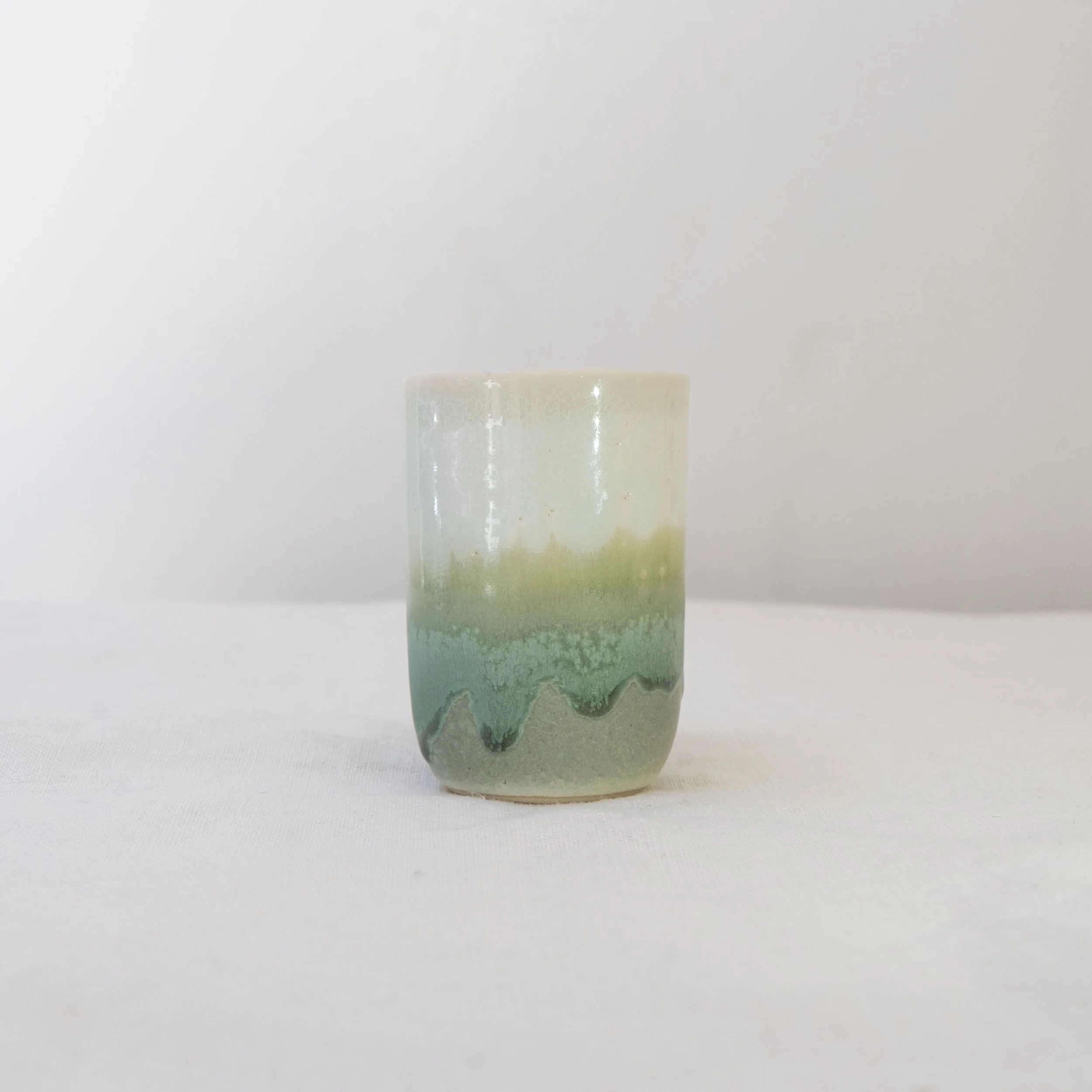 Small cup with white and green glaze, by Desvio Ceramics