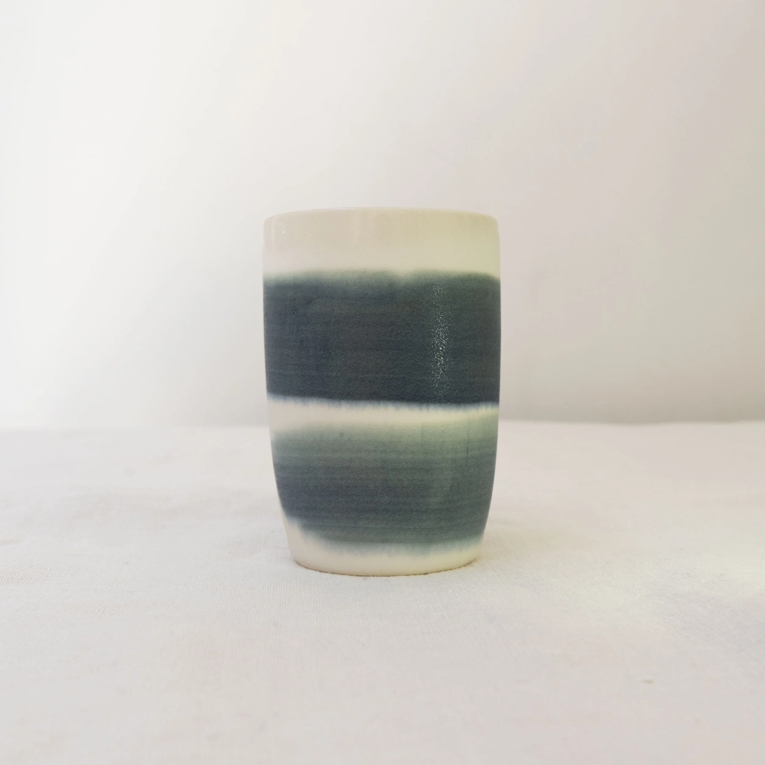 Large white cup with dark blue brush strokes, by Desvio Ceramics