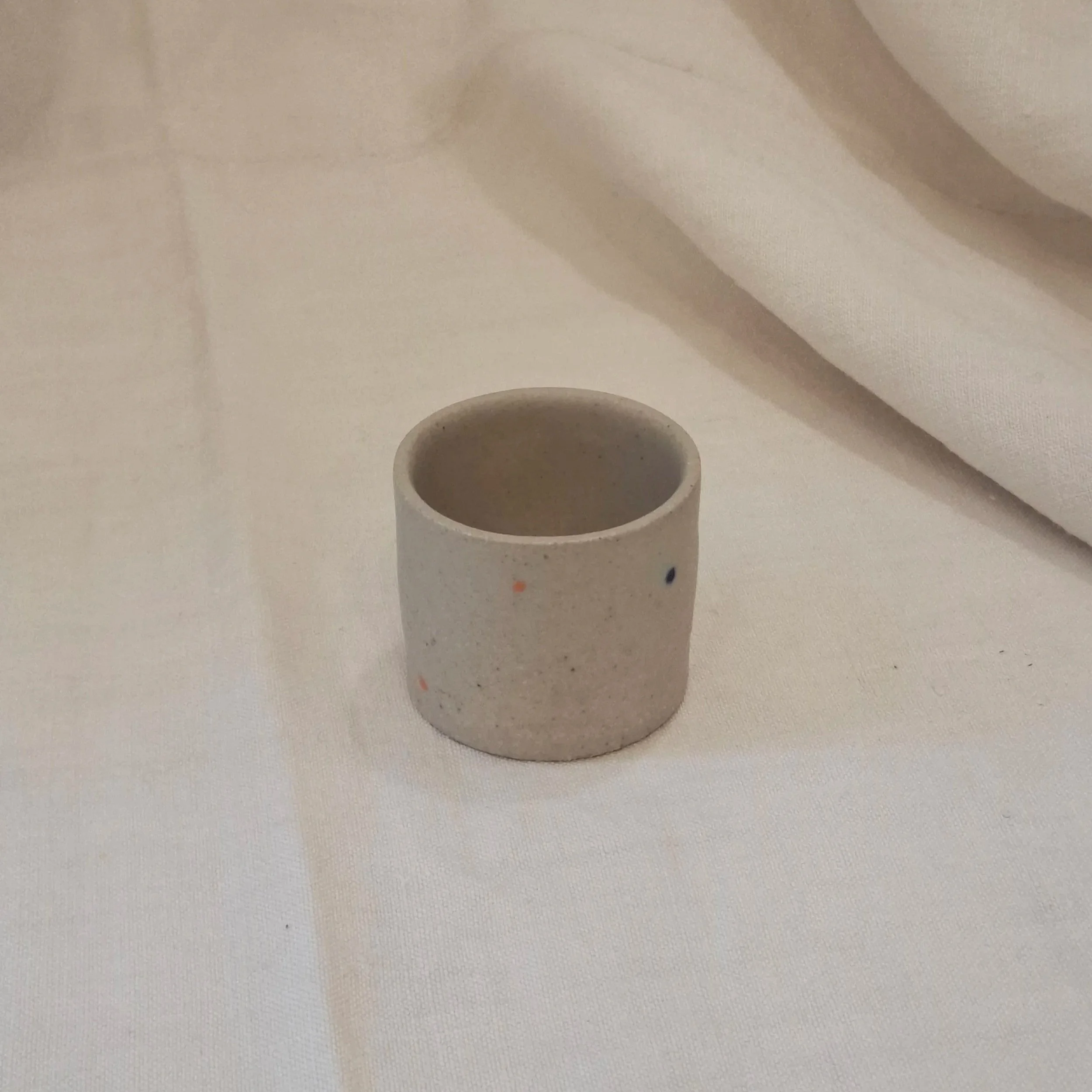 Sand stoneware colour spotted mini cup by Rita Zorro