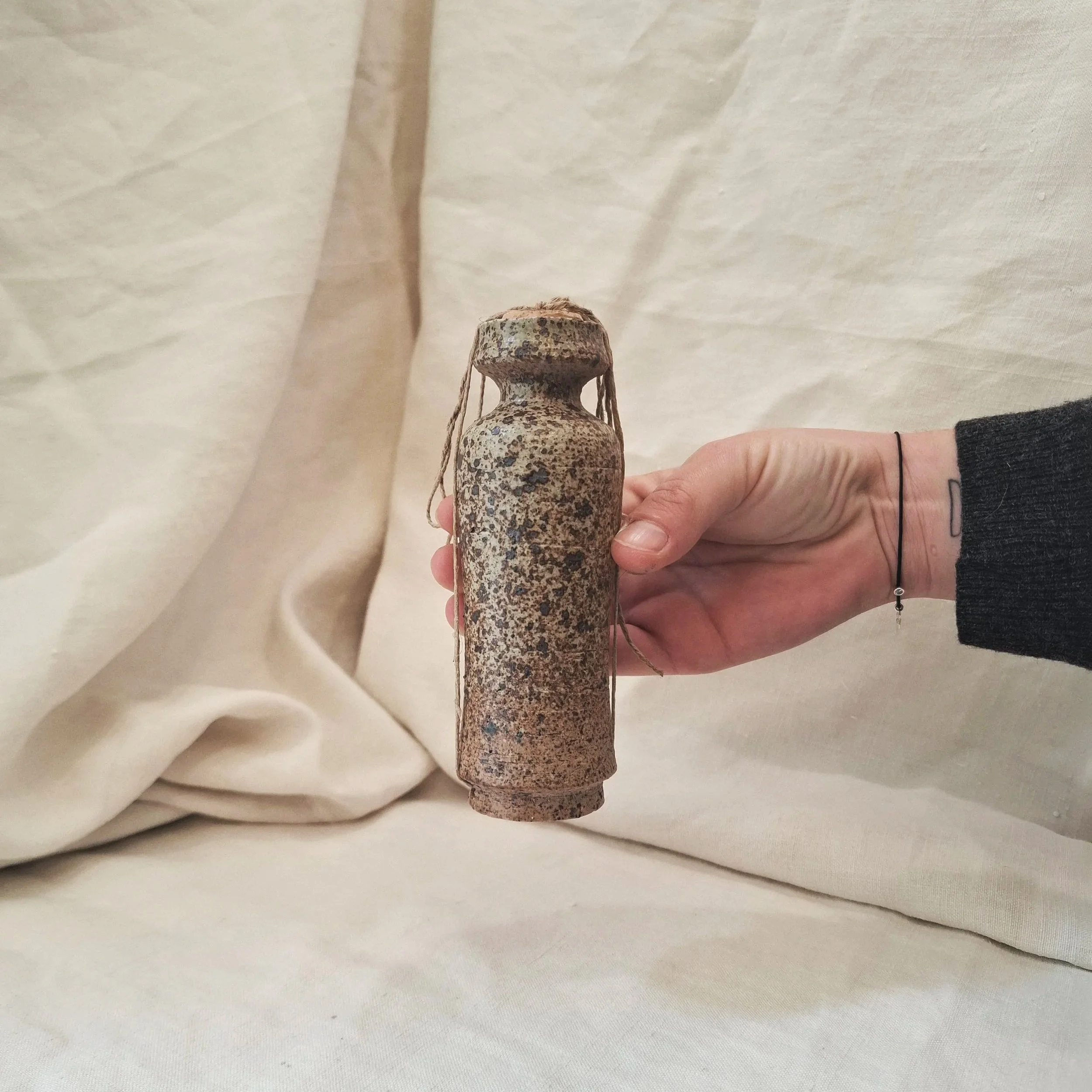 Green with brown speckles glazed stoneware bottle by Miguel Neto