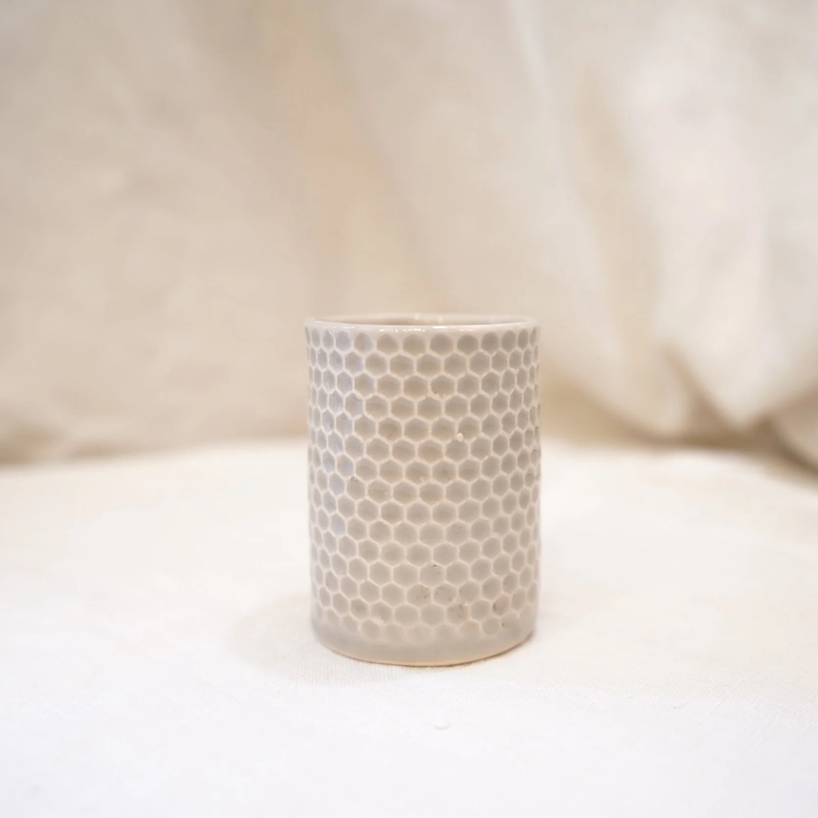 Off-white honeycomb cup by Sofia Magalhães