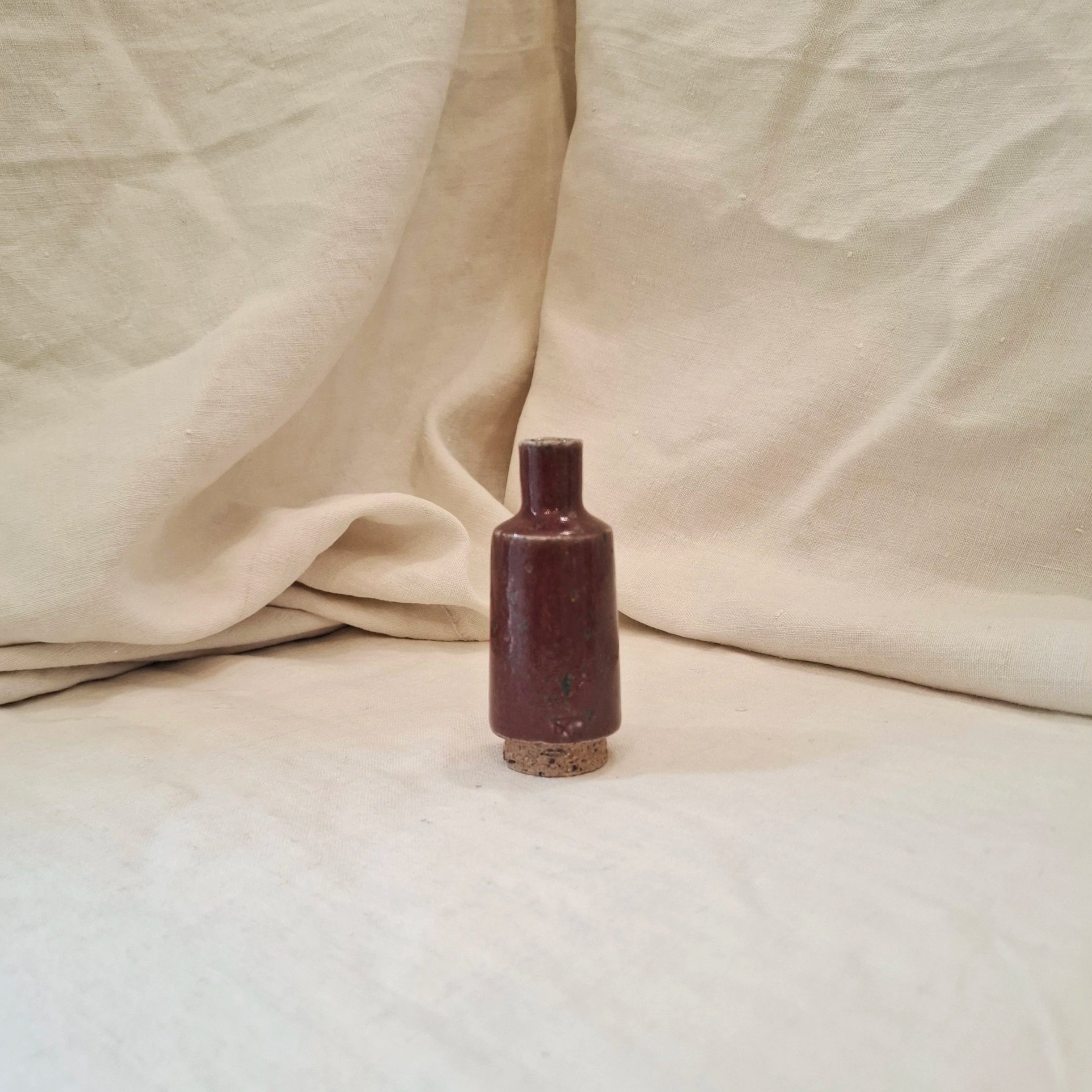 Red glazed stoneware mini bottle by Miguel Neto