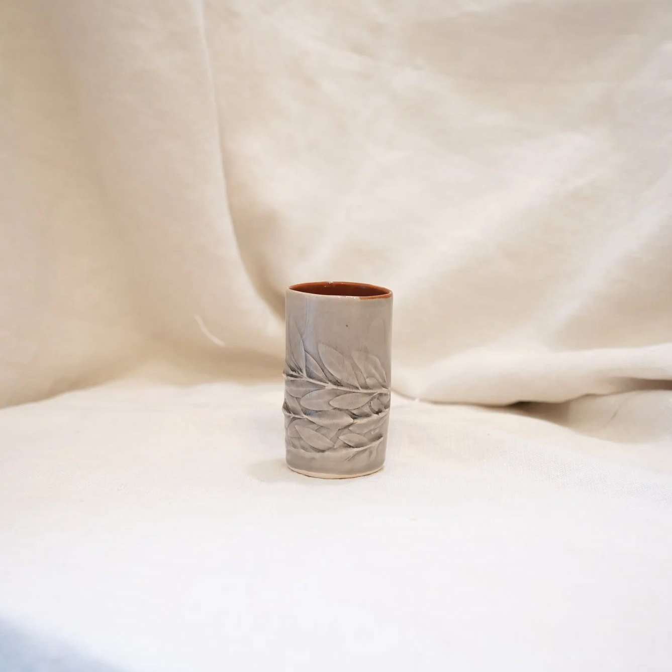 Beige and orange leaf cup by Sofia Magalhães