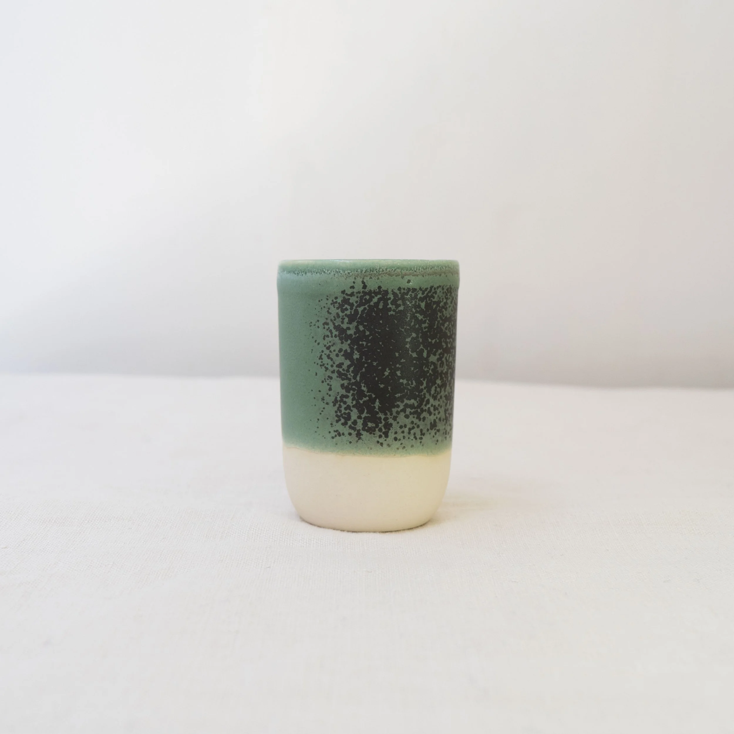 Small cup with green glaze, by Desvio Ceramics
