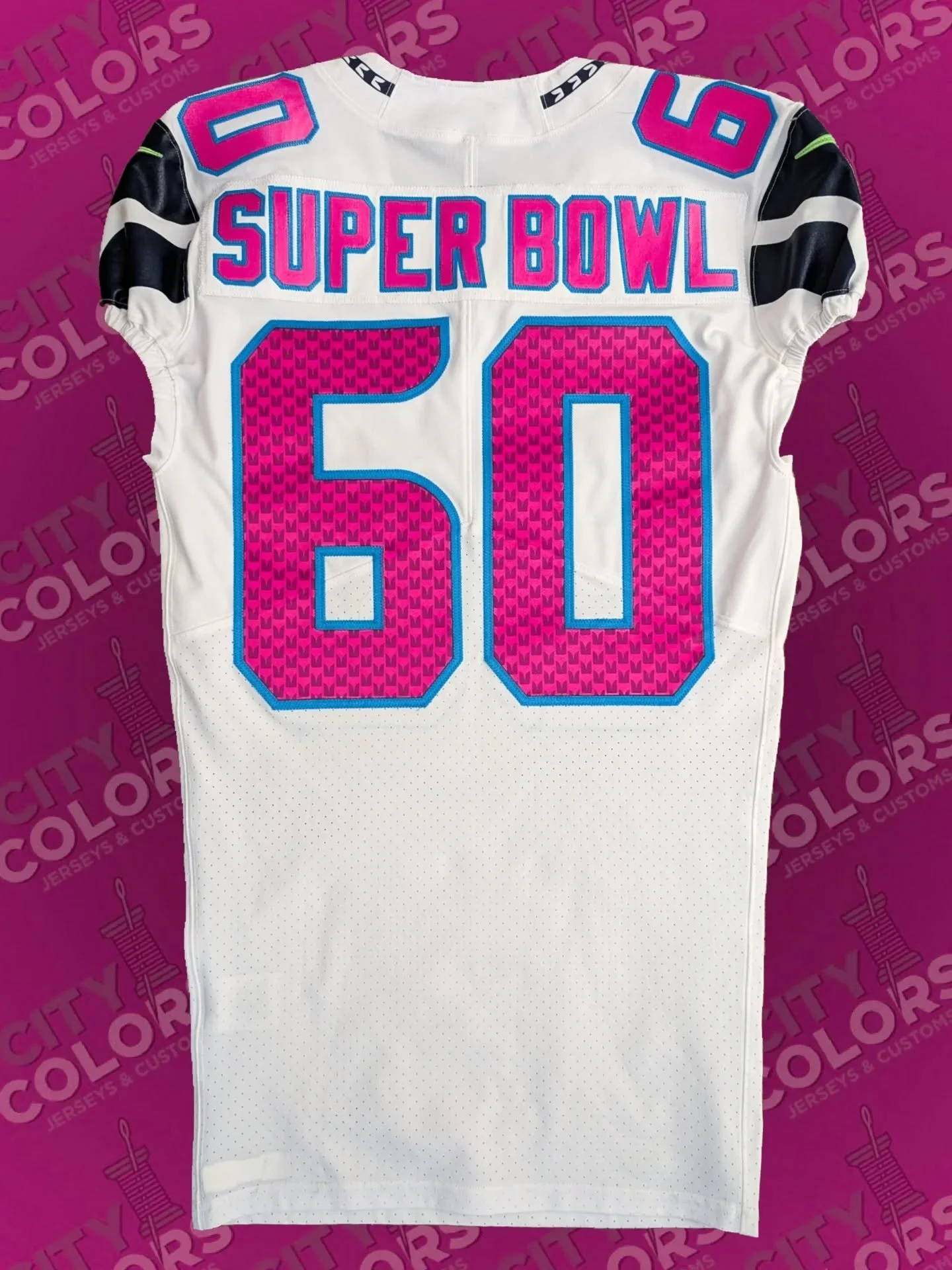 This was a post-Super Bowl custom project for a Seahawks fan, who sent in a blank team-issued jersey to make a commemorative piece. The colors were chosen from the Super Bowl LX logo. The beautifully sublimated feather-patterned number kit, native to