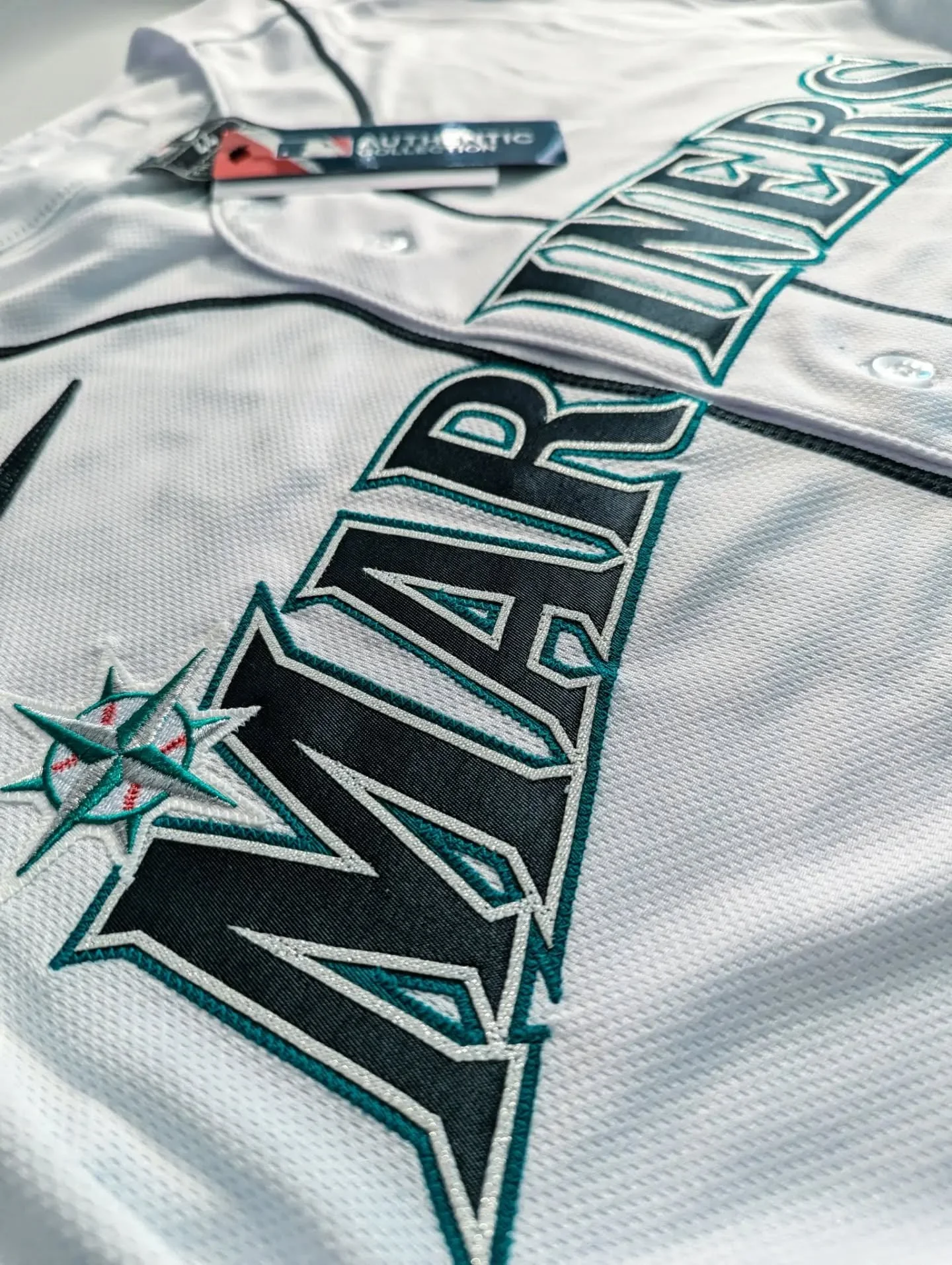 🔱 Love the metallic silver detailing here. This Nike authentic Seattle Mariners home jersey was recently customized into a Julio Rodr&iacute;guez jersey for a new customer. 🔱

#customjersey #authenticjersey #baseballjersey
