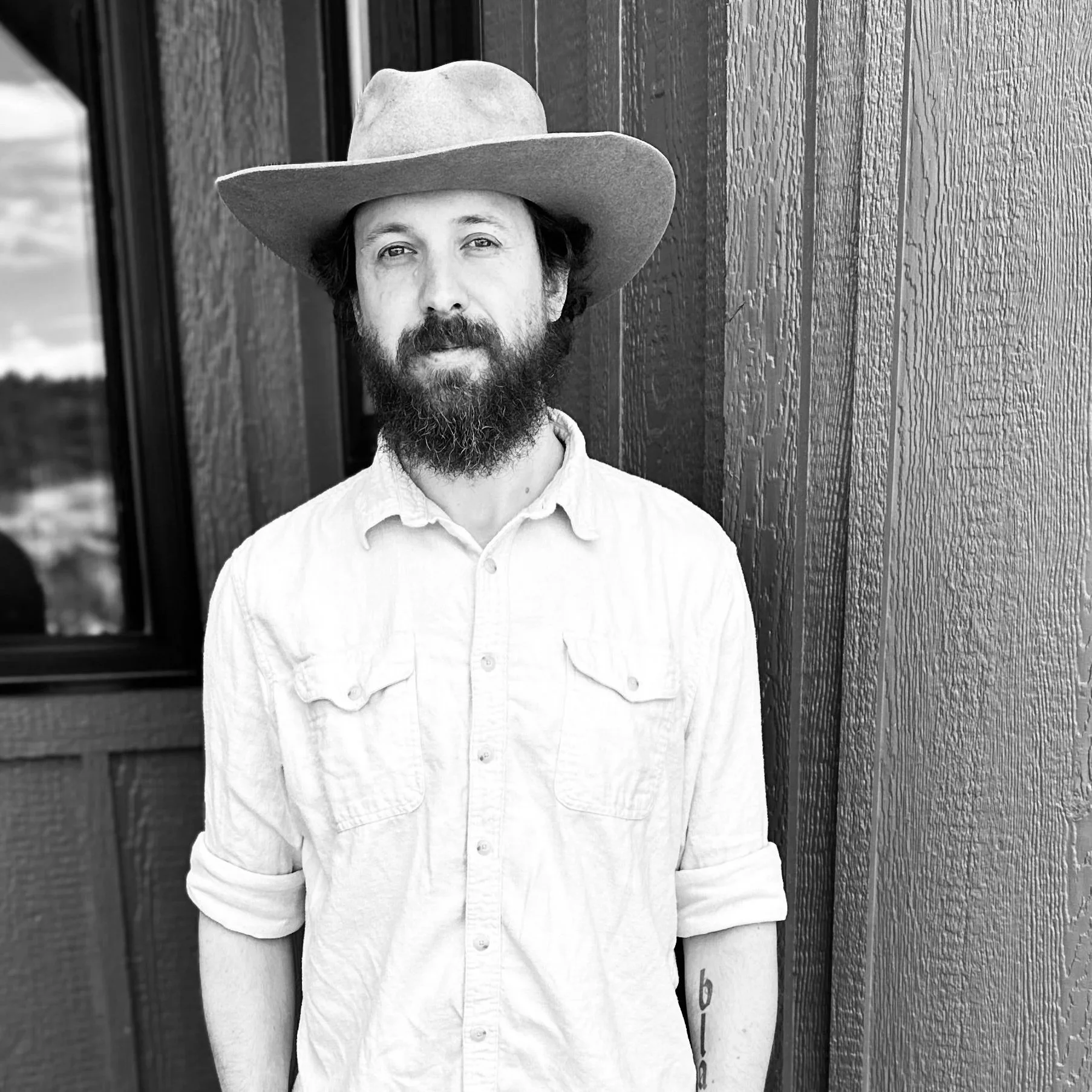 Black and white image man in Gus shaped hat natural beaver